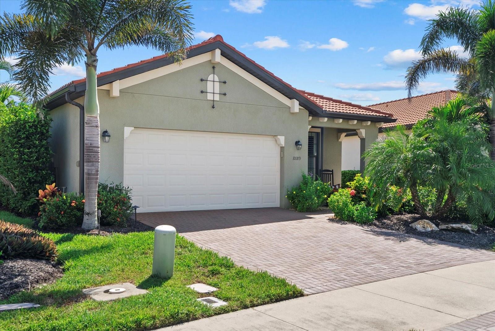 HEATED SALTWATER POOL! WATER VIEWS! HURRICANE PROTECTION! PRIVATE LANAI! Welcome to your own private slice of paradise in the guard gated community of Sarasota National. This meticulously maintained 2 bedroom, 2 bathroom home with a private office/den and 2 car garage was built in 2019 and is situated on a premium lot. This property offers WATER VIEWS in the front and in the back, with no neighbors directly behind, with an expansive green space for an unmatched sense of privacy. From the moment you arrive, you’ll notice the lush landscaping, peaceful setting from the front porch, and welcoming curb appeal. Step inside to a bright, open-concept floor plan featuring ceramic tile floors, crown molding, plantation shutters, and granite countertops throughout. The spacious great room blends seamlessly with the kitchen and dining area, making it perfect for both everyday living and entertaining. The entertainer’s kitchen is equipped with stainless steel appliances, a large center island with room for barstool seating, a corner walk-in pantry, granite countertops, and plentiful cabinetry complete with pull-out shelving. The adjacent dining area is ideally positioned for meals overlooking the pool and lake, while the living room opens through sliding glass doors to your lanai for the perfect indoor-outdoor Florida lifestyle. The spacious primary bedroom offers a custom designed walk-in closet with an en-suite bath featuring dual sinks with granite counters, a spacious walk-in shower, a separate water closet, and a linen closet for extra storage. Guests will enjoy their own private wing with a generously sized bedroom, full bath with tub/shower combo, granite vanity, and convenient hallway linen closet. A large interior laundry room provides abundant cabinetry, granite counter utility sink — making laundry day a breeze. Outside, the screened-in lanai is a showstopper, offering both a covered seating area and sunny pool deck, finished in elegant pavers. Enjoy the evening sunsets with the southwesterly facing lanai! The heated saltwater pool is perfect for year-round enjoyment which features a durable Pebbletec finish. The motorized Storm Smart hurricane protection screens allow you to control airflow and privacy, while the surrounding landscaping creates a lush and tranquil backdrop loaded with privacy. You’ll love sitting outside and soaking up the sweeping lake views and the open green space beyond — the setting feels like a private resort. Additional highlights include accordion hurricane shutters, a retractable screen on the front door and outdoor solar lighting along the front and the back of the home. Living in Sarasota National means enjoying resort-style amenities including a clubhouse with indoor dining, resort style pool with outdoor tiki bar dining, social activities, whirlpool tub, playground, fitness center, tennis, pickleball, bocce ball, and more! Sarasota National is an Audubon International Silver Signature member home to a variety of wildlife. All this is just minutes from Downtown Venice, Wellen Park, CoolToday park, shopping, dining, Gulf beaches, and easy access to I-75. This home checks every box — privacy, sweeping water views, a heated saltwater pool, and open layout, all within one of Venice’s premier gated communities. Please copy and paste the following link into your browser to view the luxury video of this home: https://player.vimeo.com/video/1109996551?badge=0&autopause=0&player_id=0&app_id=58479