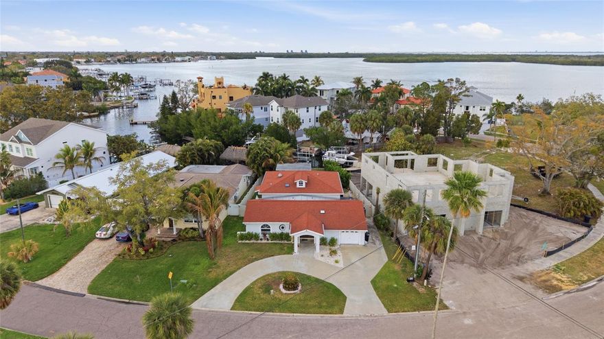 39 feet of waterfront with direct Tampa Bay access, no fixed bridges, a private dock, and boat lift — a true boater’s dream and the ultimate setup for life on the water! This beautifully appointed 4-bedroom, 3-bath pool home features a bright open floor plan filled with natural light and designed for easy living and entertaining. The kitchen offers a center island perfect for dining, a breakfast bar for additional seating, stainless steel appliances, a vegetable sink, wine cooler, and abundant storage and counter space, making it ideal for both everyday cooking and hosting guests. The first level includes two bedrooms and a full bath along with a ginormous laundry room with direct garage access, providing plenty of space and convenience. Upstairs, the private primary suite and an additional guest bedroom create a peaceful retreat. Step outside to your brick-paved covered porch overlooking the in-ground pool and custom Tiki hut with electricity — the perfect spot for relaxing or entertaining while enjoying the view of your waterway and boat-ready dock. With quick access to open water, you can spend your days fishing in Tampa Bay, cruising to Weedon Island, or enjoying endless boating adventures. Conveniently located near downtown St. Petersburg, Tampa, and the beautiful Pinellas County beaches, this home offers the perfect blend of comfort, functionality, and the ultimate Florida waterfront lifestyle.