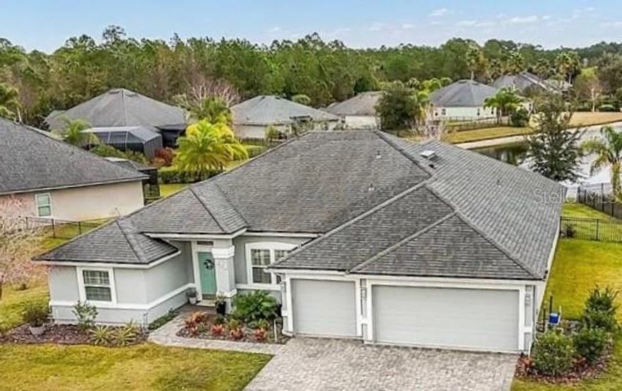 A SHOWSTOPPER IN GATED WOODLAKE! This beautifully upgraded 4-bedroom home with a 3-car garage is perfectly positioned on an oversized homesite with breathtaking pond and fountain views enjoyed from most rooms and the expansive screened lanai. Located just steps from the community pool and playground, with easy access to I-95, RV and boat storage, and only minutes to historic downtown St. Augustine, shopping, boating, fishing, and area attractions, this home offers both convenience and tranquility.

The heart of the home is the spacious, light-filled kitchen featuring granite countertops, an upgraded backsplash, under- and over-cabinet lighting, a breakfast nook, and all new LG stainless steel appliances. Soaring 10-foot ceilings enhance the elegant formal living and dining areas, creating an inviting space for everyday living and entertaining. The primary suite is a true retreat, offering a flexible sitting area overlooking the water.  The guest bathroom has a new double vanity.  

The home has been extensively enhanced with exceptional 2025 upgrades, including complete exterior paint and trim, updated landscaping, luxury vinyl plank flooring throughout, plantation shutters throughout the entire home, all new LED lighting with added dimmer switches, all new ceiling fans, and a new sliding glass door designed to showcase the stunning pond and fountain views. Outdoor living shines with a newly added Paver stone patio. Gorgeous new pavers in the screened lanai and walkway, and a thoughtfully designed entertainment and seating area perfect for relaxing or hosting guests.

Additional highlights include a fully fenced backyard offering privacy and serene water views, a 110-foot irrigation well, low HOA fees, NO CDD FEES, and the charm of Woodlake—an intimate gated community of just 96 homes featuring a pool and playground. Sellers can accommodate a quick move-in. This is Florida living at its finest and a home that truly must be seen to be appreciated.