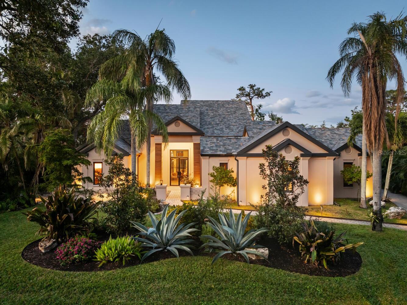 Nestled in the prestigious gated enclave of The Oaks Bayside in Sarasota, this Sedona-inspired retreat was recently updated from wall to wall creating a like brand new home. The estate seamlessly blends modern luxury, comfort, and serenity. With almost 4,000 SQF and boasting 4 generously sized bedrooms and 3 1/2 baths, this residence has been thoughtfully renovated with the finest finishes, including newer impact windows, retractable window walls, a sleek tile roof, custom concrete flooring, and exquisite baths and fixtures to go along with the state-of-the-art kitchen, equipped with top-tier Wolf and Sub-Zero appliances. Soaring vaulted ceilings create an expansive, airy ambiance, while large windows frame stunning lake views, offering the perfect backdrop for the sparkling pool and expansive spa, complete with tranquil water features. With disappearing sliders throughout, the home can let the air and light flow easily from outside to in. Enjoy breathtaking sunsets from your private oasis or stroll a kayak or paddleboard to the nearby boat launch for effortless access to Sarasota Bay and the Gulf, thanks to the newly reopened Midnight Pass. Situated on a secluded .40-acre lot, this property offers a serene retreat, featuring a Zen garden surrounded by lush landscaping. Residents of The Oaks enjoy world-class amenities, including championship golf, fine dining, tennis, fitness, and swimming. At 49 Osprey Point Drive, every detail has been meticulously crafted for those who seek refined living and unparalleled elegance.