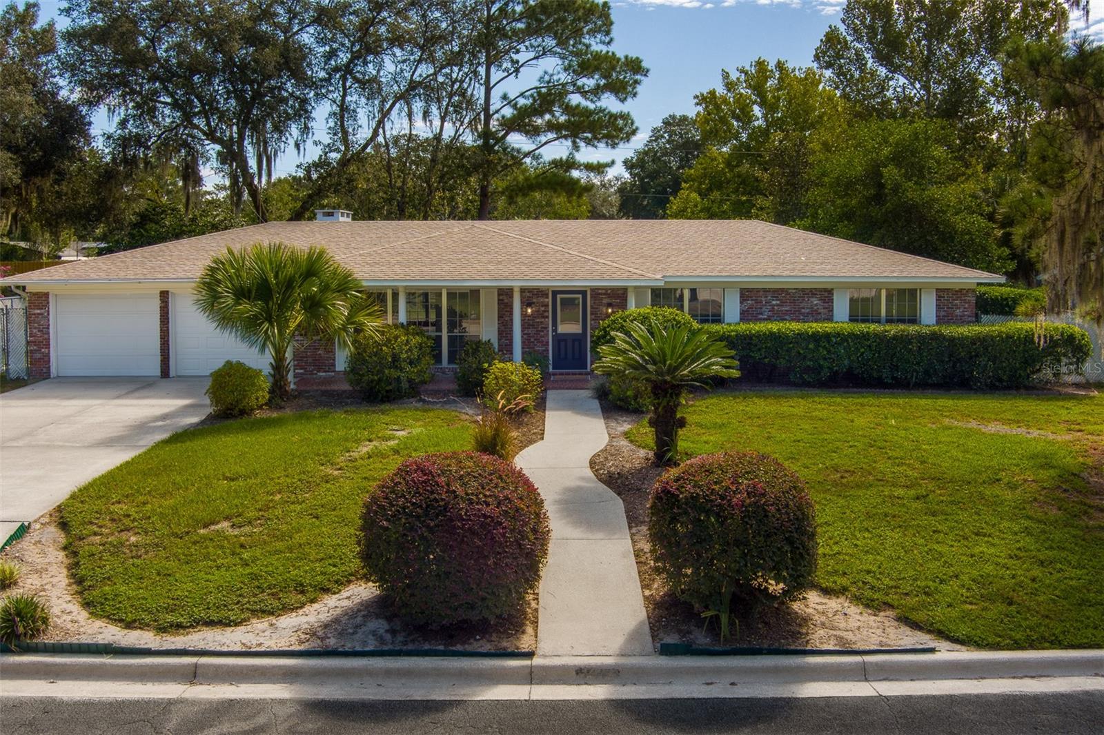 Located in the highly desirable Northwest Gainesville area, this spacious and well-maintained original owner brick home offers character, flexibility, and a setting that’s hard to beat. With 5 sizeable Bedrooms, 2.5 Baths, and an abundance of living space, there’s room to truly make it your own. From the moment you arrive, you’ll appreciate mature landscaping and an inviting exterior that hints at the home’s warm, welcoming personality. ~ ~
Inside, parquet floors set the stage for timeless style. The layout includes formal living and dining rooms, as well as two large great rooms/flex spaces perfect for hosting, relaxing, or creating the hobby or media space you’ve always wanted. The kitchen is outfitted with generous cabinetry and counter space, storage, a breakfast nook and is centrally located for easy access when entertaining or everyday cooking. ~ ~
Practical features include indoor laundry, a fireplace, and an attached oversized 2 car garage (with 2 separate garage doors), extra workspace, and abundant storage to keep everything organized. The solid block concrete construction offers peace of mind, while the fully fenced backyard, and covered patio provide a private outdoor retreat for gatherings or quiet evenings. ~ ~
This home blends classic charm with versatile spaces in Hidden Pines—just minutes from UF, primary and secondary schools, shopping, dining, parks, and top local amenities. Whether you’re looking to preserve its vintage style or add your personal touch, this beauty is ready for its next chapter.