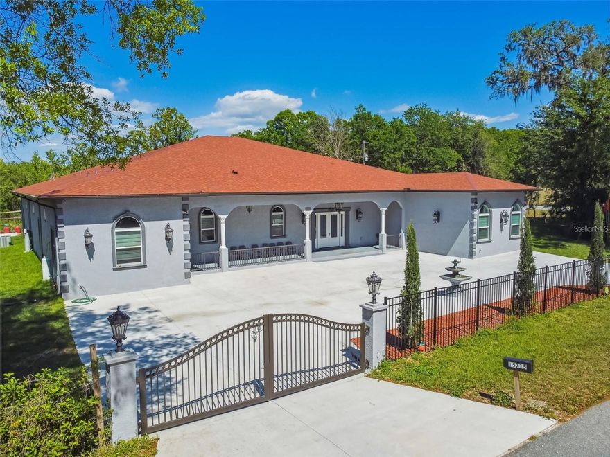 Discover this stunning energy-efficient custom estate nestled on nearly 5 acres of serene land, offering privacy, space, and luxury living. From the moment you step inside, you’ll notice the thoughtful craftsmanship—soaring ceilings, premium tile flooring, and a seamless layout designed for comfort and elegance.

The gourmet kitchen is perfect for hosting, complete with brand-new appliances and ample counter space. For entertainment, enjoy your private theater room, a dedicated game area, and a spacious back patio ideal for gatherings.

This home features generously sized bedrooms, spa-like bathrooms, and expansive walk-in closets. A versatile meditation room or office can serve as a fifth bedroom if needed. Outdoors, part of the backyard is already outfitted as a chicken coop, with plenty of room left for gardening or recreation.

Located just 8 minutes from the new Minneola Publix and Turnpike access, and only 8 minutes to Montverde Academy, this location is a hidden gem close to Clermont’s conveniences.

Schedule your private showing today—this is a home you don’t want to miss!
