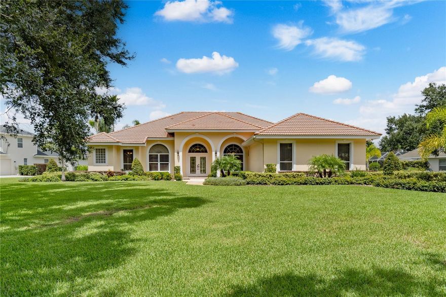 One or more photo(s) has been virtually staged. Gated and guarded waterfront property in the prestigious community of Wyndham at Lake Winterset—welcome to 105 Wyndham Drive. This premium residence is ideally positioned within one of the area’s most desirable executive enclaves. From the moment you arrive, you’re greeted by an elegant brick-paved entry, stately wrought-iron gates, and manicured landscaping that changes beautifully with the seasons. Beyond the gates, oak-lined streets and impressive custom estates create a timeless setting where neighbors enjoy leisurely walks and bike rides beneath the canopy of mature trees.
Perfectly situated on an oversized 0.80-acre waterfront lot, the home captures one of Wyndham’s most tranquil settings, with peaceful pond views and the soothing sounds of a cascading fountain. The elegant façade, classic tile roof, and lush landscaping create undeniable curb appeal. Inside, architectural detail meets modern comfort. The 3-bedroom, 3-bath design includes an executive office that can easily serve as a fourth bedroom, along with soaring ceilings, crown moldings, upgraded wood flooring, and expansive windows that bathe the interiors in natural light and serene water views.
The kitchen blends elegance and function with custom cabinetry, glass-front display cases, granite countertops and backsplash, detailed moldings, a built-in desk nook, and stainless-steel appliances. The adjoining family room features a cozy fireplace and built-in wine rack—perfect for relaxed evenings or entertaining guests. Whether it’s the sophistication of the formal living and dining rooms or the inviting warmth of the family room, each space has been thoughtfully designed for effortless living.
The private primary suite serves as a retreat, offering space for a sitting area, dual walk-in closets, and a spa-like bath with sconce lighting, jetted tub, walk-in shower, and dual sinks. Additional bedrooms are generously sized and thoughtfully separated for privacy, while the executive office with built-ins and a closet adds exceptional flexibility.
Step outside to experience the best of Florida living. A covered lanai with audio and TV connections opens to an expansive paver patio, lagoon-style heated pool and spa, and an outdoor firepit—all overlooking the sparkling pond and fountain for a truly serene backdrop.
The oversized two-car garage features epoxy flooring and extensive built-in storage. Recent updates include new wood flooring in all bedrooms and the office, new tile flooring in the primary and guest baths, expanded patios, upgraded irrigation, refreshed landscaping, and new paint inside and out.
Residents of Wyndham enjoy private community amenities including tennis and pickleball courts, basketball, a playground, and secure manned entry—all within a beautifully maintained lakefront setting. Conveniently located less than an hour from Disney World and about 1.5 hours from both Tampa and Orlando International Airports, you’ll also enjoy close proximity to Winter Haven’s shopping, dining, medical facilities, and the world-famous Chain of Lakes.
Don’t miss this rare opportunity to own one of Wyndham’s finest waterfront homes—combining luxury, privacy, and the irreplaceable beauty of a sprawling 0.80-acre waterfront setting.