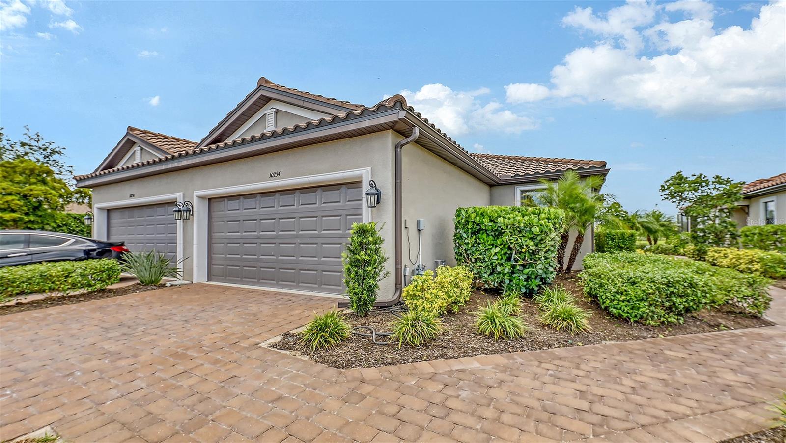 Located in the beautiful community of Esplanade on Skye Ranch. This popular Ibis model, paired villa is just 3 years old & 1530 sq. ft. under air. Situated on a premium lake front lot & a short distance to the community pool. This Taylor Morrison built gem features 2 generous bedrooms plus a den with 2 full baths. Open floor plan with upgraded tiles throughout the living area. Kitchen has white cabinets, granite counters & stainless appliances. Attached 2 car garage & natural gas features. Amazing community amenities: the Hub which features a Bohemian bar & grill, resort style pool, fitness center, pet park, sport fields & parks. Fee includes ground maintenance, community pool & recreation facilities.