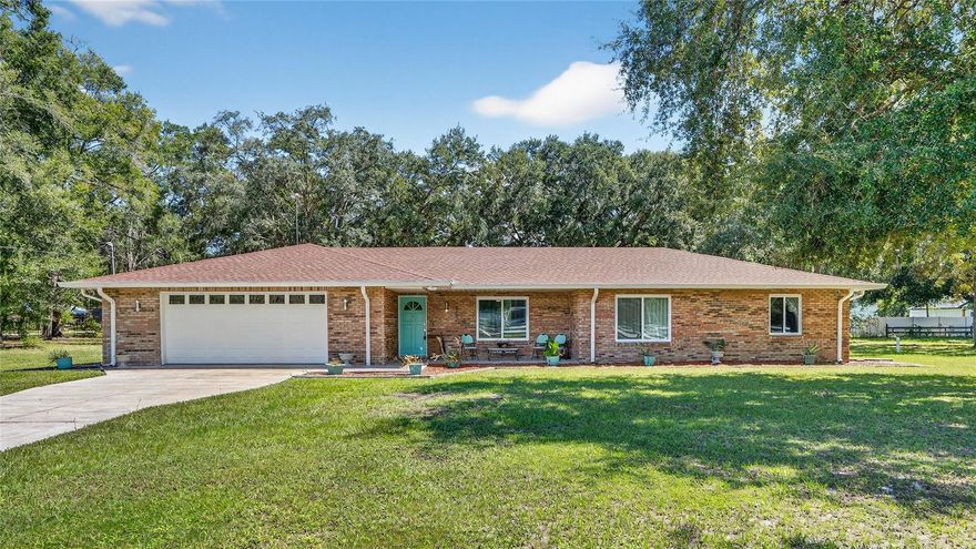 Great opportunity to own this unique brick home that offers a perfect blend of timeless charm and modern upgrades. Situated on a tranquil 1.10-acre lot beautified with majestic oak trees. The property features a private backyard oasis with a pool, waterfall, and covered lanai, ideal for relaxation or entertaining, complemented by a fully fenced yard with dual gated entrances for privacy. Inside, the spacious split floor plan boasts brand-new tile flooring, recent upgrades including sleek sliding glass doors and new energy-efficient windows, all enhancing comfort and natural light. This home offers both luxurious and highly functional, truly a serene retreat with ample storage, including an oversized garage and shed. Plenty of room for all your toys. A must see!