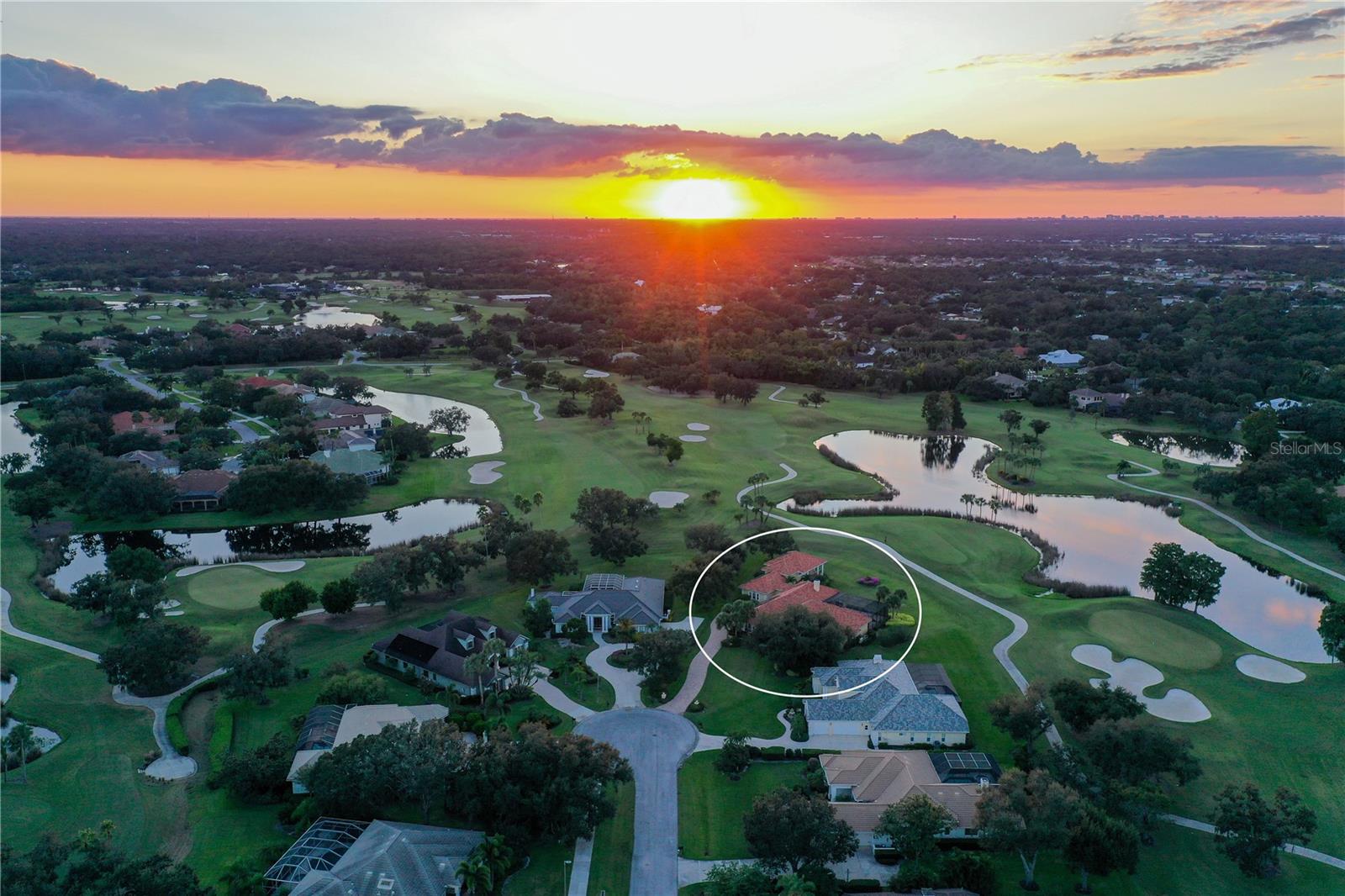 Set on a serene cul-de-sac within the prestigious Laurel Oak Estates, this custom-built residence captures the essence of Sarasota’s coveted golf-course lifestyle. Poised on nearly an acre with sweeping fairway and lake views, the home offers more than 5,100 square feet of beautifully designed living space enhanced by timeless architectural detail, modern functionality, and effortless indoor-outdoor flow.
A private winding drive and manicured landscaping introduce the stately façade, where double entry doors open to a grand foyer with high ceilings and walls of large windows that fill the interiors with natural light. The spacious living and dining areas feature custom built-ins and millwork, with expansive sliders framing sunset views of the sparkling pool and golf course beyond. Perfect for entertaining, the gourmet kitchen combines rich wood cabinetry with granite countertops, a large center island, double ovens, built-in refrigerator, wet bar area, and casual dining nook overlooking the fairway. The adjoining family room offers a warm gathering space anchored by solid wood built-ins and a gas fireplace, with seamless access to the screened lanai for alfresco living.
The primary suite is a private retreat with peaceful golf and water views, two custom walk-in closets, and a spa-inspired bath complete with soaking tub, separate shower, dual vanities, and private water closet. Three additional guest suites provide generous accommodations—two sharing a Jack-and-Jill layout, and one with a full en-suite bath—each thoughtfully designed for comfort and privacy. The theater room is equipped with platform seating, custom cabinetry, 120” screen, surround sound, remote-controlled lighting, and 4K projector. A true highlight of the home is the second-floor bonus suite, currently used as an art studio, featuring vaulted tongue-and-groove ceiling, built-in desks, a full bathroom, and an expansive balcony capturing unforgettable sunset vistas across the course.
The screened outdoor living area defines the Florida lifestyle, showcasing a heated pool and spa, outdoor kitchen, and multiple seating areas for relaxing or entertaining. Mature landscaping, accent lighting, and the home’s ideal southwest exposure create a tranquil backdrop year-round. Additional features include plantation shutters, central vacuum, a three-car side-entry garage with golf-cart parking, and a whole-house solar system offering efficiency and peace of mind.
Nestled behind the gates of Laurel Oak Country Club, residents enjoy access to 36 championship holes of golf, tennis and pickleball courts, a junior Olympic pool, fitness facilities, and a vibrant social calendar—all available with optional membership. Beyond the gates, you’re moments from Sarasota’s best amenities, including UTC Mall’s upscale shopping and dining, Nathan Benderson Park, and downtown Sarasota’s world-class arts, culture, and waterfront entertainment. Siesta Key and Lido Key beaches are within easy reach, completing the perfect blend of privacy, luxury, and convenience.
With its exquisite craftsmanship, prime location, and inspiring golf-course vistas, this Laurel Oak Estates residence delivers the ideal balance of sophistication and relaxed Sarasota living—an exceptional opportunity for those seeking elegance within one of the region’s most prestigious gated communities.