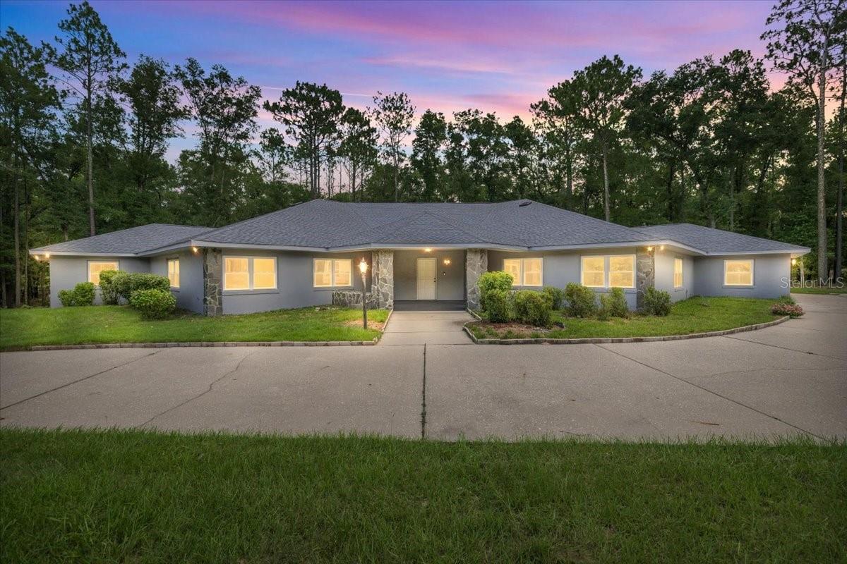 One or more photo(s) has been virtually staged. Escape to the end of a quiet cul-de-sac, on 2.36 private acres and you will find a one-of-a-kind custom-built home, purposefully designed for accessibility, comfort, and creative living. This gorgeous home is handicap ready for current or future use combining barrier-free functionality with eclectic charm, offering incredible versatility for its next owner. Inside, the galley kitchen is a chef’s dream, featuring two commercial-grade Sub-Zero refrigerators, double built-in ovens, two butler’s pantries, and an abundance of storage and prep space. The layout includes two spacious primary suites, a full-sized library, and an oversized office with extensive built-in filing cabinets and workstations—ideal for a home business or creative studio. Did I mention this home has 5695 sq ft under air. The home also includes a climate-controlled interior efficiency apartment, perfect for guests, live-in care, or rental income. The oversized 28’ x 27’ garage offers ample storage, with an attached air-conditioned workshop, and two additional detached storage buildings with roll-up doors and electricity—ideal for hobbies, equipment, or professional use. Recently updated with a brand-new roof (house and storage buildings), all-new windows with custom interior casements, and fresh exterior paint, the big-ticket items are already taken care of, giving you a head start in making this incredible home your own. The home is equipped with two Lennox 5-ton A/C units one includes an Aquefier system which turns the hot steam into hot water along with two hot water heaters and two electric panels. There is also a Generac 20 KW whole home generator with a 250 gallon underground propane tank. This property offers boundless potential—perfect for multi-generational living, a sound or photo studio, small business headquarters, or simply a private creative retreat. Let your imagination roam—this home was built with intention and awaits your next vision.The outdoor space is vast and peaceful with abundant wildlife and a property that is full of mature trees and beautiful landscape. Located in The Forest of Rainbow Springs, residents enjoy some pretty sweet perks for a very low yearly HOA fee. They include community swimming pool, clubhouse, bocce ball, pickle ball, tennis, basketball, driving range, restaurant, disc golf, walking trail and access to your own private 3-acre residents park which is just a 1500-foot peaceful kayak or canoe paddle from the first magnitude Rainbow River State Park head spring. This exclusive community river park has 2 large pavilions, barbecue grills, segregated bathrooms, outdoor showers, private swimming area, kayak launch and supervised security for safety and peace of mind. Dunnellon’s Rainbow Springs is a rare gem. You will also be able to experience world class golf just next door at Juliette Falls Country Club. This ideal location places you at the doorstep of small town living at its finest in addition to being close to Ocala, Gainesville and vacation attractions found in nearby Tampa and Orlando. Don't miss your opportunity to visit this lovely home and property.