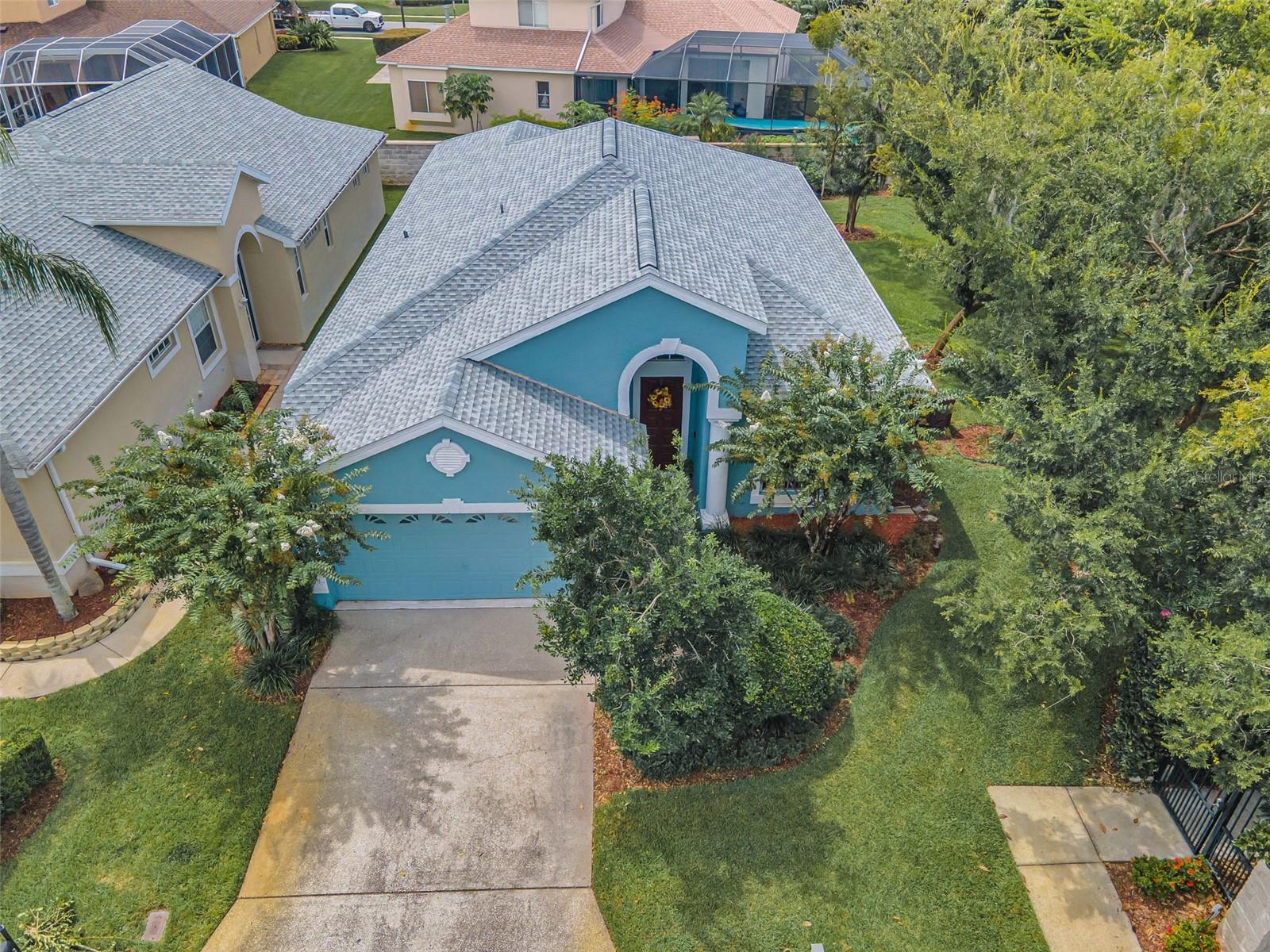 This uniquely designed and RECENTLY UPDATED Fox Hollow villa in the gated Peachtree subdivision enjoys custom architectural enhancements to suit selective home buyers. Topped with a NEW ROOF in 2025 and NEWER flooring, this OVERSIZED CORNER LOT is very private with a large side yard -- one not typically found in villa communities. The gently winding streets and pristine curb appeal create a charming venue for this lovely 2 bedroom/2 bath home. You'll appreciate the screened lanai’s views of the exquisite landscaping and perimeter stone fence as you indulge in alfresco dining. The attached patio offers the ideal place to BBQ, entertain, and enjoy the Florida sunshine. Delightful community amenities include a WALKING PARK, A DOG PARK, PICKLEBALL COURTS, and a SPARKLING POOL aside a covered veranda. Inside, the foyer's illuminated and vaulted barrel ceiling welcome you into the cool tile flooring and spacious stylings of the gorgeous Great Room accented with triple tray ceilings and graceful pillars showcasing views of the peaceful lanai and yard. The adjacent kitchen, along with its stainless appliances, was customized to include a full wall separating it from the Great Room. Lit by recessed fixtures and peek-a-boo transoms, a window triplet surrounds the cozy breakfast nook while the formal dining room is highlighted by French doors accompanied by a striking eyebrow window revealing scenic views of the outdoor greenery along with a second patio treated to NEWER FRENCH DOORS. Both spacious bedrooms are airy with the master suite boasting sliders to the lanai and a magnificent walk-in closet; its ensuite featuring a garden soaking tub and separate shower room. Custom-outfitted with a single door, the den can be converted into a 3rd bedroom, the ultimate home office, or a crafting space. Two immaculate full baths and a two-car garage complete this one-of-a-kind Trinity home.