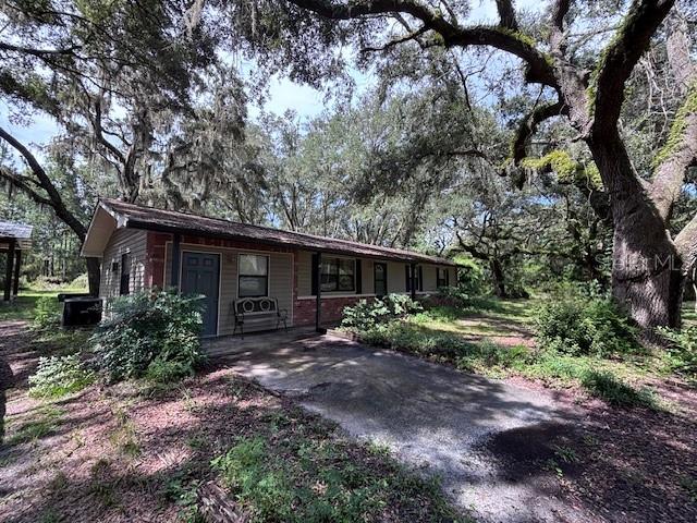 CHIEFLAND, FL ~ 3 bed/2 bath country home on just over 1 acre with newer 36x24 pole barn that has a metal roof and concrete floor, ideal for parking your vehicles, boat, or that perfect backyard workshop. The home is 1344 square feet (1728 under roof) and features a large kitchen and laundry room, heat pump, vinyl floors in living areas and carpet in bedrooms. There is also a 16x12 bonus room that could be a 4th bedroom, a recreation room, or an office. The backyard is field-fenced with a gate and offers many options, currently has a chicken coop. Shingle roof is approximately 11 years old and new metal roof will be installed prior to closing. The perimeter of the property is lined with magnificent ancient oaks for privacy. The property located behind this is 140 acres of planted pines for added peace and quiet. GREAT location on a paved road between Chiefland and Fowler's Bluff on the Suwannee River, home of the Treasure Camp Restaurant on the river for dining and enjoying the beautiful river view. Only a 20-minute drive to the island of Cedar Key for more dining, shopping or fishing on the Gulf of America, and an hour to Gainesville, Ocala, or Crystal River. Multiple places to launch your boat and numerous nearby crystal clear springs. High and dry, NOT in a flood zone according to FEMA website. Previously financed USDA so should qualify for any type of financing. If you're looking for a country home, this is it!