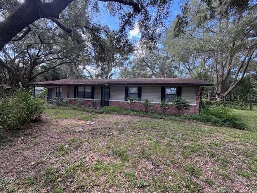 CHIEFLAND, FL ~ 3 bed/2 bath country home on just over 1 acre with newer 36x24 pole barn that has a metal roof and concrete floor, ideal for parking your vehicles, boat, or that perfect backyard workshop. The home is 1344 square feet (1728 under roof) and features a large kitchen and laundry room, heat pump, vinyl floors in living areas and carpet in bedrooms. There is also a 16x12 bonus room that could be a 4th bedroom, a recreation room, or an office. The backyard is field-fenced with a gate and offers many options, currently has a chicken coop. Shingle roof is approximately 11 years old and new metal roof will be installed prior to closing. The perimeter of the property is lined with magnificent ancient oaks for privacy. The property located behind this is 140 acres of planted pines for added peace and quiet. GREAT location on a paved road between Chiefland and Fowler's Bluff on the Suwannee River, home of the Treasure Camp Restaurant on the river for dining and enjoying the beautiful river view. Only a 20-minute drive to the island of Cedar Key for more dining, shopping or fishing on the Gulf of America, and an hour to Gainesville, Ocala, or Crystal River. Multiple places to launch your boat and numerous nearby crystal clear springs. High and dry, NOT in a flood zone according to FEMA website. Previously financed USDA so should qualify for any type of financing. If you're looking for a country home, this is it!