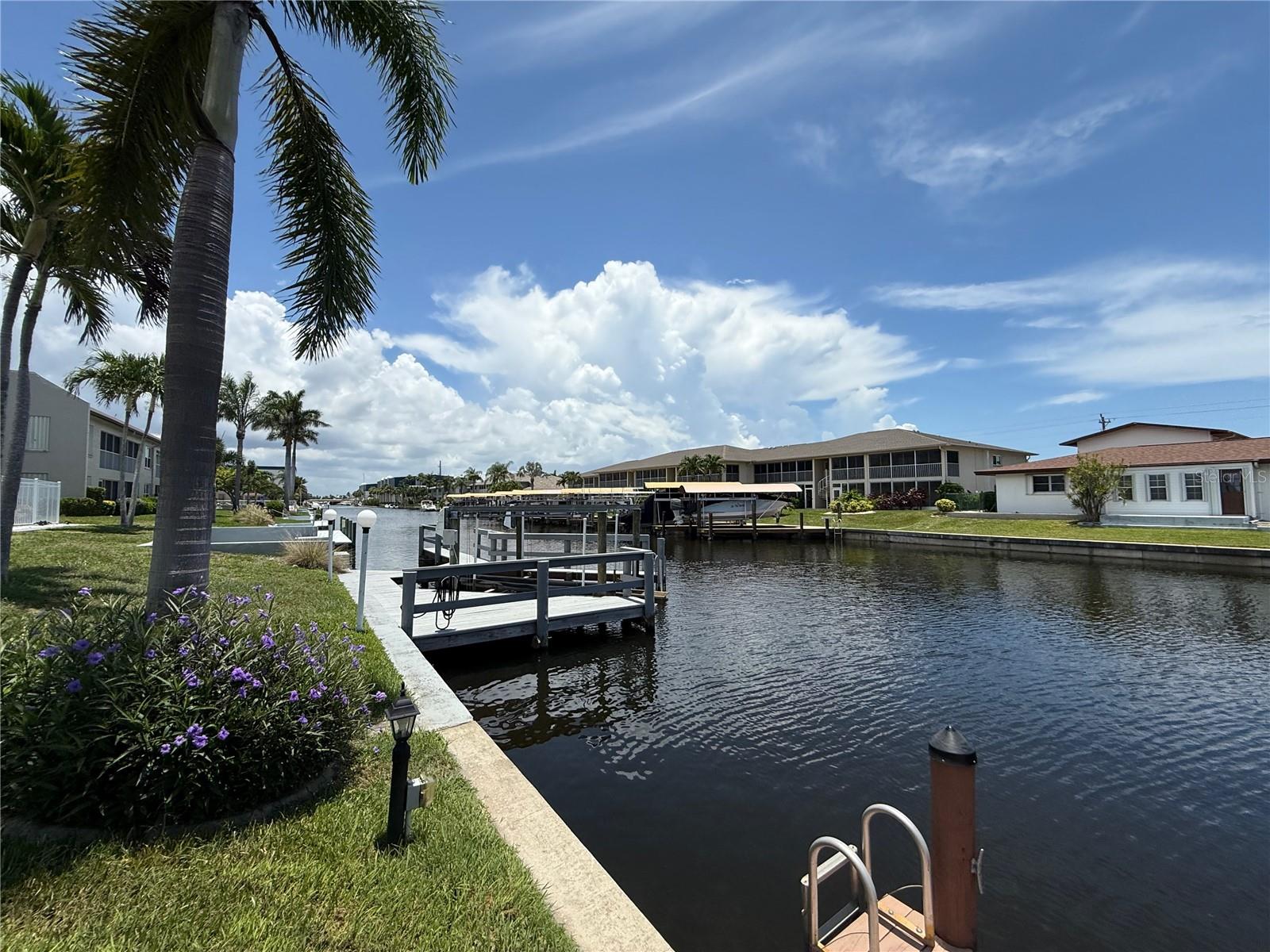 Welcome Home to your very own Waterfront Oasis with Gulf Access End Unit 1st Floor Condo in Cape Coral featuring 2-bedroom, 2-bathroom. Offering the perfect blend of COASTAL LIVING and MODERN CONVENIENCE at 46 Dockside CONDO COMMUNITY ONLY 12 UNIT COMPLEX 55 & OLDER. Whether you’re looking for a year-round residence, seasonal escape, or a lucrative vacation rental, this WATERFRONT GEM has it all.
Step inside to this WELL MAINTAINED, BRIGHT and OPEN CONCEPT layout featuring an UPDATED KITCHEN, dedicated Dining Area, and spacious Living Room/Den — perfect for entertaining or relaxing. The Primary Bedroom boasts an En-Suite Bathroom, Built-In Desk with Bookcase & Lg Walk-In Closet, while the second bedroom offers generous closet space and easy access to the second full bathroom.
Enjoy serene views of the MALAGA CANAL from your private outdoor LANAI with IN-UNIT LAUNDRY and extra storage for added convenience. This End Unit 1st Floor Condo includes RESERVED PARKING for peace of mind and accessibility. Just steps from your Lanai, the complex offers a relaxing COMMUNITY POOL overlooking the canal, BOAT DOCK available on a first-come, first-serve basis, and direct Gulf access — only a bridge away from the CALOOSAHATCHEE RIVER.
This boater’s dream location is just minutes from the white sandy beaches of Sanibel, Captiva, and Fort Myers Beach. Enjoy quick access to downtown Cape Coral, as well as nearby Naples, Bonita Springs, Estero, and Marco Island — all offering endless options for dining, shopping, and entertainment.
Whether you’re cruising the waterways, lounging poolside, exploring the best of Downtown Cape Coral or fishing off the dock, this Condo is your ideal coastal retreat overlooking the Malaga Canal.
Don’t miss this opportunity to own a piece of PARADISE with GULF ACCESS right outside your lanai door! Schedule your private showing!
THE BEACH IS CALLING......HAVE YOU?