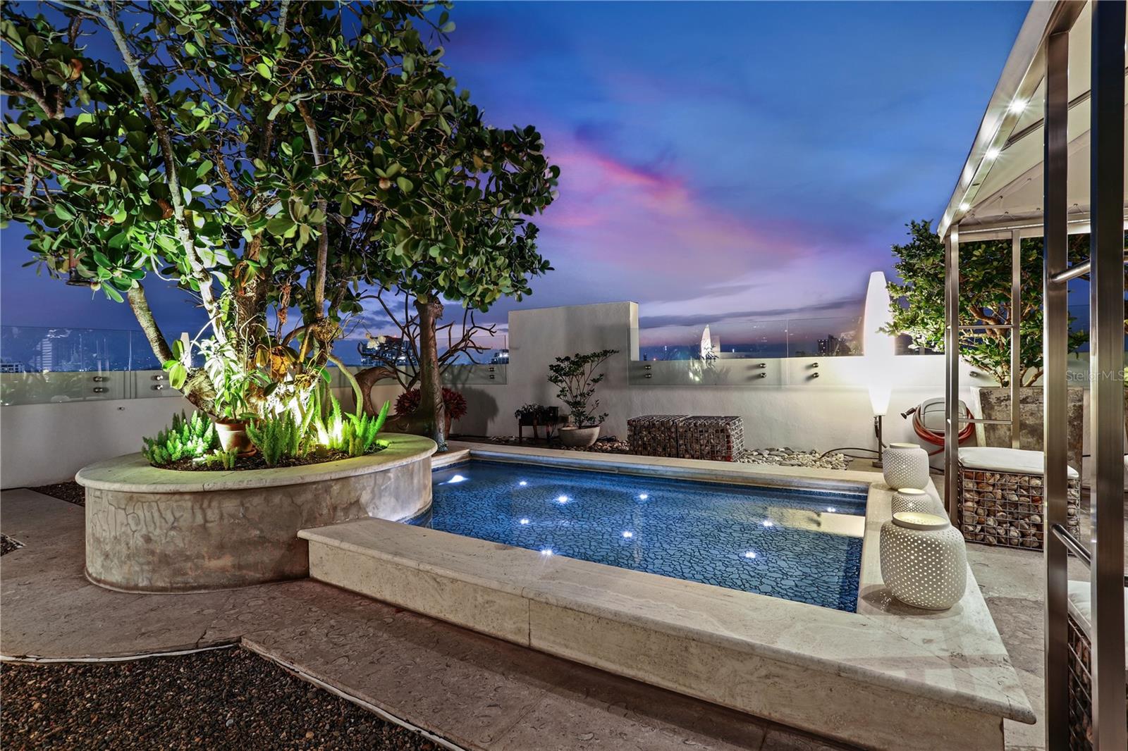 Stylish and modern two-level Penthouse in the exclusive The Residence at the Park, a boutique condominium located in the corner of Cervantes and Luchetti Streets, one of the most desirable addresses in Condado. With a gross living area of 5,590 square feet, this impeccably designed, and tastefully decorated duplex, is currently configured with two ensuite bedrooms that can be converted into three, four bathrooms, four covered parking spaces and two expansive covered and uncovered terraces with spectacular ocean and city views.
Main Level: The elevator opens to an elegant entry foyer that leads to a light-filled grand room consisting of a formal living room, comfortable sitting area with built-in bar, formal dining room with double-height ceiling featuring an impressive decorative skylight, and a balcony overlooking the Stella Maris Park. The main floor also includes a home office with custom built-in units, adjoining family room, laundry room, and Italian designed Snaidero kitchen equipped with Wolf and Subzero appliances.
Upper Level: Accessed by a stainless steel and glass staircase and a ThyssenKrupp hydraulic private elevator, the upper floor is an entertainer’s delight featuring a versatile open room with generous lounge and seating areas, fully equipped kitchenette and informal dining room with full glass Nana folding windows and doors that open to one of the two rooftop terraces. The northeast exposure terrace offers an intimate seating area around a meditation garden where you can enjoy the relaxing Atlantic Ocean views and its refreshing breeze. The inviting southwest terrace is centered around a reflective pool complemented by a casual seating area. Enjoy alfresco dining and outdoor entertaining with panoramic views and breathtaking sunsets.
Additional features include natural stone and marble floors, recessed custom lighting, water sprinklers in the terraces, HEOS sound system, storage unit, 24-hour doorman, full backup generator, water cistern, fitness center, and residents’ lounge.
Generous proportions, stunning vistas, exquisite finishes, and exceptional outdoor space make this property truly special and your ideal home in Puerto Rico.
The Residence at the Park is conveniently located near schools, parks, restaurants, beaches, shopping and more.