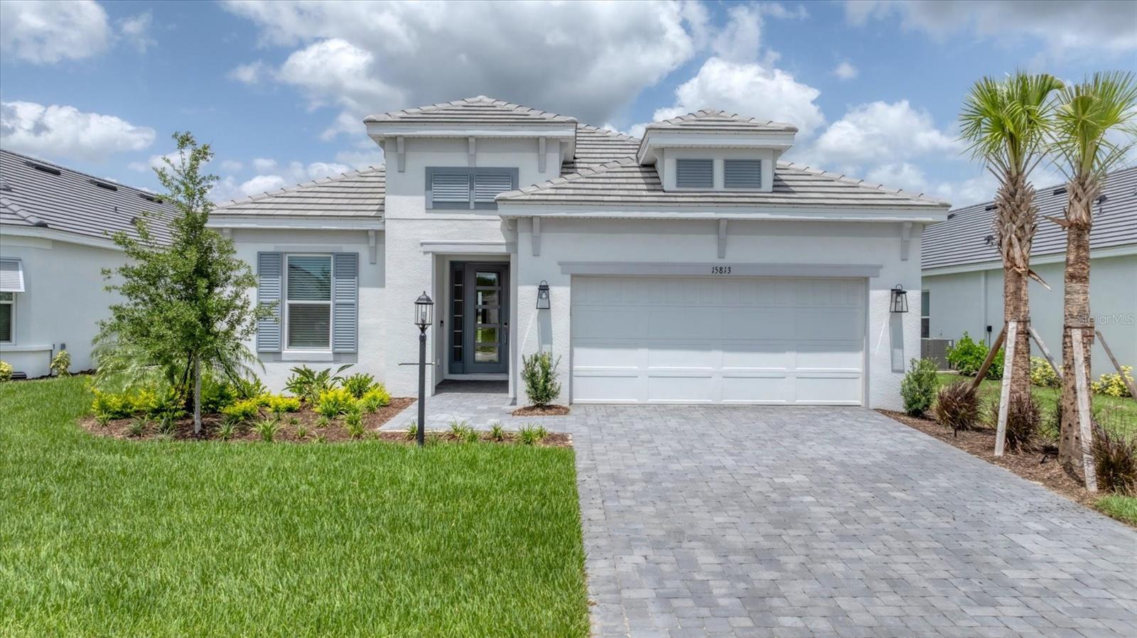 One or more photo(s) has been virtually staged. **GOLF-INCLUSIVE Luxury Home on the 10th Hole in Esplanade at Azario Lakewood Ranch**
Live the Florida lifestyle in this beautifully upgraded Lazio model, ideally positioned on the 10th hole in the highly sought after, gated golf community of Esplanade at Azario. With golf membership included and just a short stroll to fabulous amenities, this home offers resort-style living at its finest. Enjoy wine tastings, cooking classes, fine dining, a state-of-the-art fitness center, and a luxurious spa — all within your own community. Whether you’re savoring poolside bites or elegant meals overlooking the fairway, Azario offers a lifestyle like no other.
From the moment you arrive, the coastal elevation and glass front door set the tone for the light, bright interior. Inside the home, you’ll find 10-foot ceilings, 8-foot doors, tray ceilings, crown molding, and wide-plank light oak flooring throughout. The home offers 3 spacious bedrooms, each with its own en suite bathroom, plus a versatile den perfect for a home office or media room. The gourmet kitchen is a chef’s dream, featuring quartz countertops, an apron-front sink, GE gas cooktop and wall oven, under-cabinet lighting, and extended cabinetry under the island for added storage. The open-concept layout seamlessly connects the kitchen, dining, and living areas—ideal for both entertaining and everyday comfort. Two sets of sliding glass doors open onto the expanded covered lanai, blending indoor and outdoor living and showcasing sweeping views of the golf course. The lanai is prepped with gas, electric, and plumbing, making it easy to design your dream pool and outdoor kitchen. The primary suite is privately tucked away at the rear of the home, with tranquil golf course views. The luxurious en suite bathroom features dual vanities, a large walk-in shower, upgraded lighting, and designer finishes. At the front of the home, two additional guest suites offer full baths and total privacy, perfect for visitors. Located in the heart of Lakewood Ranch, you’ll be minutes from world-class shopping, dining, “A”-rated schools, miles of walking trails, and the sparkling Gulf Coast beaches. Don't hesitate, book your showing today!