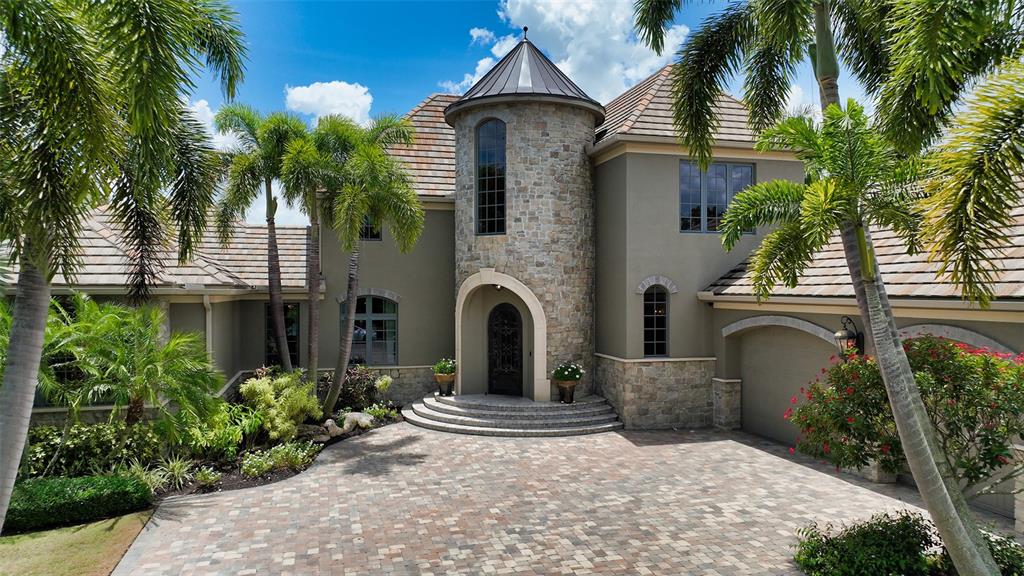 Set in The Lake Club on a picturesque homesite and built with an unsurpassed level of construction and materials, this custom Westwater build, reminiscent of a European castlette, overflows with character and charm in every room. Showcasing wood and travertine flooring throughout main living areas, exquisite and unique ceiling details, venetian plaster walls, extensive millwork, and iron accents, this unique residence is truly a masterpiece. Grand living room features soaring coffered ceilings, French doors to lanai, and an oversized limestone gas-powered fireplace. Dining room offers a sophisticated open barroom and French door access to a travertine courtyard dressed with floral trellises and fountain. Kitchen, open to family room, is a dream with oversized center island, banquette seating, solid wood soft-close cabinetry, unique granite counters, stone hood, hand-painted tiles and hidden pantry closet. French doors open to lanai, where the views are quaint and peaceful, and friends and famiy can enjoy a saltwater pool and spa, outdoor kitchen and dining, motorized screen, and lush beautiful landscaping. Master suite is a romantic oasis with sizeable closets and impressive bathroom suite with private his/her spaces. Second level of home offers an additional luxurious master suite with double vanity, walk-in shower and walk-in closet. Home provides a third bedroom on main floor set privately from others plus a bonus room for use as office, den or 4th bedroom. Additional highlights of home include impact glass throughout, A/C in garage, sconce lighting throughout home, steam shower in pool bath, built-in speakers, security cameras, A-niks mosquito prevention system, smart home features and so much more. The Lake Club community enjoys 24-hour guard-gated security, the Grande Clubhouse, restaurant/bar, two resort pools, fitness, sports courts, fishing, and trails. Lakewood Ranch is the best-selling multi-generational community in the USA near world-class dining, shopping, beaches, and A+ schools.