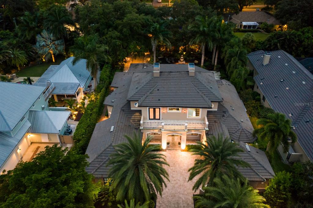 Cherokee Park Perfection! Set on an idyllic lot in one of Sarasota's most sought after neighborhoods, you will find this meticulously maintained custom home. The location is ideal, with quick access to Sarasota Memorial Hospital, downtown, world famous Siesta Beach and A rated Southside School which is just one block away. Southside Village with Morton's Gourmet market, restaurants and shops is a mere 1/2 mile +/- away. The home itself features a fantastic floor plan with travertine marble and mahogany flooring throughout. The huge gourmet kitchen features all Viking stainless appliances including a 6 burner gas cooktop and two dishwashers, huge center island and breakfast bar, 150+/- bottle climate controlled wine cellar, granite counters and solid wood cabinets. The kitchen is open to a large family room overlooking the pool and gorgeous backyard. The living room features a gas fireplace and a unique travertine marble flooring with mahogany inserts. The massive master suite is divine complete with sitting area, breakfast bar, his and her walk in closets with gorgeous built ins, a newly renovated master bath complete with a walk in shower with rain head and multiple wall shower heads, large separate soaking tub and a TV built in to the mirror over the vanity. Upstairs you'll find 3 guest bedrooms, 2 en suite, and a fabulous bonus room complete with a bar with granite counters, sink and refrigerator and a balcony overlooking the pool and Selby garden like grounds. The outdoor living in this home is like no other with it's heated pool and spa, huge covered dining area that can seat 30+ for a meal and a brand new summer kitchen complete with a gas fireplace. Overlooking the pool is a fantastic outdoor bar with concrete counters, sink, ice maker and refrigeration all under roof. The entire patio and pool deck is travertine marble as well. Mature oaks and landscaping abound back here, professionally lighted and you even have your own bocci court. The current owners have spared no expense with this home and have recently replaced all three ac units, the gas pool heater, updated master bath, updated pool bath and a new washer and dryer set to name just a few. This is Sarasota living at it's finest! Home is being offered furnished. Room Feature: Linen Closet In Bath (Primary Bathroom).