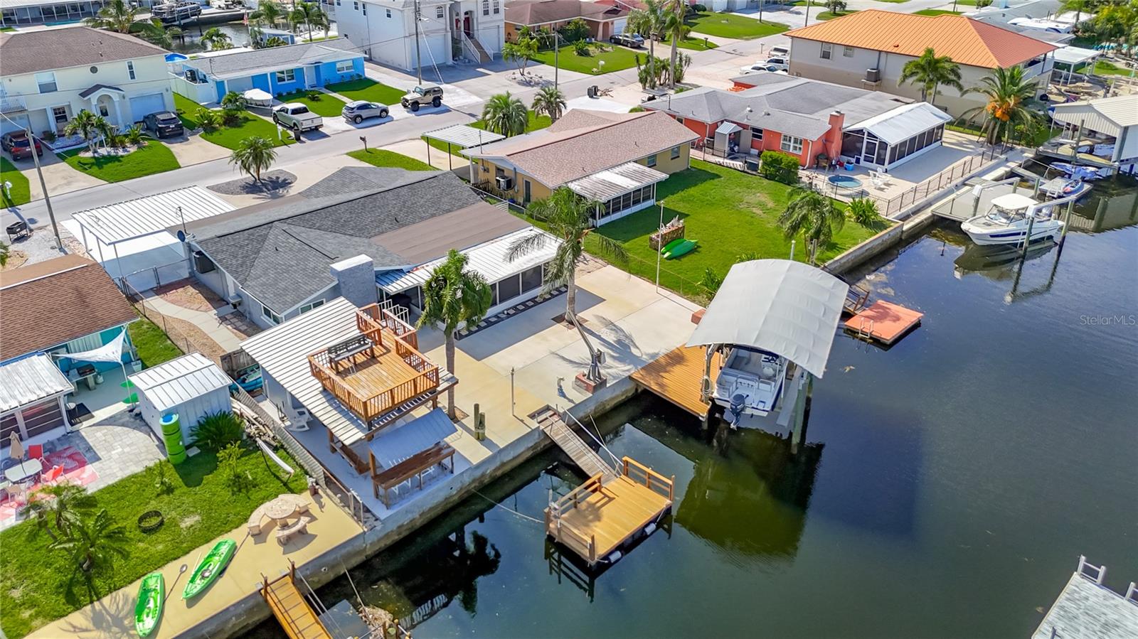 Opportunity awaits with this beautiful and completely remodeled and renovated 3/2/1 located in the waterfront community of SEA RANCH!! Nestled along a deep-water canal and just minutes away from the breathtaking Gulf waters, this completely renovated gem of a home combines modern luxury with the serene charm of waterfront living. These homeowners have carefully brought this home back to the gem that it is with its wonderfully laid out floor plan that is well suited to entertain all your friends and family. Make this space your retreat or your forever home. This home has new, new, new! From the ground up, all you see is brand new! Enjoy a home that has the makings of a new built. Thoughtful Renovations: New flooring has been installed throughout all living spaces, while fresh interior paint breathes new life into each room and new exterior paint gives the home an amazing/updated look. Every corner of this residence has been renovated bought back to new conditions. New roof (2025), (Hurricane Impact windows, doors 2020) 2025-electric, plumbing, pipes, fixtures, bathrooms, walls, simply put a brand-new home from the ground up. The versatile layout allows for easy customization, make the space yours with its spacious gourmet Kitchen, which is the heart of this home, the undoubtedly brand-new kitchen, featuring stunning stone countertops, an island for gatherings, new cabinets, a sleek new sink, and top-of-the-line appliances. Whether you’re preparing a quiet dinner or hosting a festive gathering, this space is sure to inspire your culinary creativity. Luxurious Bathrooms: Experience spa-like tranquility in the two updated full baths. Each bathroom has been thoughtfully designed with premium finishes, providing a relaxing oasis for your daily routine. Indoor-Outdoor Living: The enclosed lanai showcases amazing water views, and an extended outdoor space for entertaining. But there is more! Step outside to discover the cabana and its upper deck! Imagine afternoon drinks, a beautiful sunset, and cool breezy evenings. BONUS: Included with this sale is the boat as seen in the photos! Another BONUS: this owner is also including the majority of the furniture seen and his golf cart, enjoy afternoon drive around the community, meet your neighbors and friends with it! Waterfront Access and ADDED Amenities: With no bridges and direct access to the deep-water canal, and your very own floating dock, spacious decking along with a 14,000 lb. capacity remote control Boat lift, a MUST for boating enthusiasts, all there for you to revel in the ease of getting out on the water and protection of your craft when not in use. The property's dock is equipped with electric, and plumbing piped for a fish cleaning station or boat cleaning area to make your aquatic adventures even more enjoyable. Outdoor Entertaining: Just look at this maintenance free backyard with its amazing space for entertaining, this extensive outdoor space is perfect for gatherings, barbecues, or simply soaking up the sun. Yard Space: a side yard area for safe storage behind its gate, a circular driveway and a 2 carport. This exquisite home is more than just a property; it’s a lifestyle waiting for you to embrace! Enjoy the luxury of waterfront living coupled with the vibrant community that surrounds it. Whether you’re an avid boater, a nature lover, or simply seeking a peaceful retreat, this stunning home has it all. Don’t miss your chance to own this incredible waterfront sanctuary!