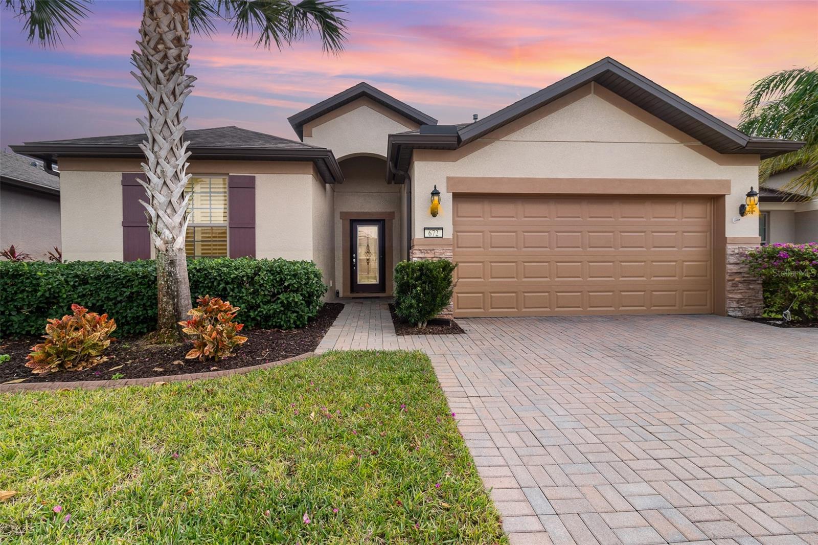Exceptional Summerwood Model in Del Webb Orlando! Meticulously maintained 2-bedroom plus den, 2-bath home in a prime location near the Montecito Clubhouse. This popular open-concept floorplan features a gourmet kitchen with espresso cabinets, granite countertops, stainless steel appliances, gas stove, pendant and recessed lighting, and an oversized island with bar seating. The adjacent formal dining room offers additional flexibility for hobbies or a reading area.
Enjoy abundant natural light, tall ceilings, arched entryways, and a grand foyer with custom etched-glass front door. Guest bedroom includes plantation shutters and a full bath with granite counters. French doors open to a spacious office or optional third bedroom.
The primary suite is privately located at the rear of the home with no backyard neighbors. Features include dual vanities, an oversized tiled walk-in shower, linen closet, and a large walk-in closet with custom shelving.
Additional highlights include a spacious laundry room with new washer and dryer, built-in shelving, and generous storage. The 2-car garage offers extra space for golf cart parking or a workshop, plus overhead storage and a pull-down attic ladder.
Enjoy outdoor living on the fully covered, screened lanai with multi-slide patio doors. The backyard is beautifully landscaped with rubber mulch and full guttering. Curb appeal includes paver driveway, concrete curbing, fresh exterior paint, and mature landscaping with palm trees.
Fantastic savings from energy-efficient solar panels and a low HOA of $277/month with no additional clubhouse fees. Del Webb Orlando is a 55+ gated community offering indoor/outdoor pools, fitness center, tennis, pickleball, bocce, walking trails, clubhouse, social activities, optional golf, and RV/boat storage. Close to Disney, shopping, dining, healthcare, and more.