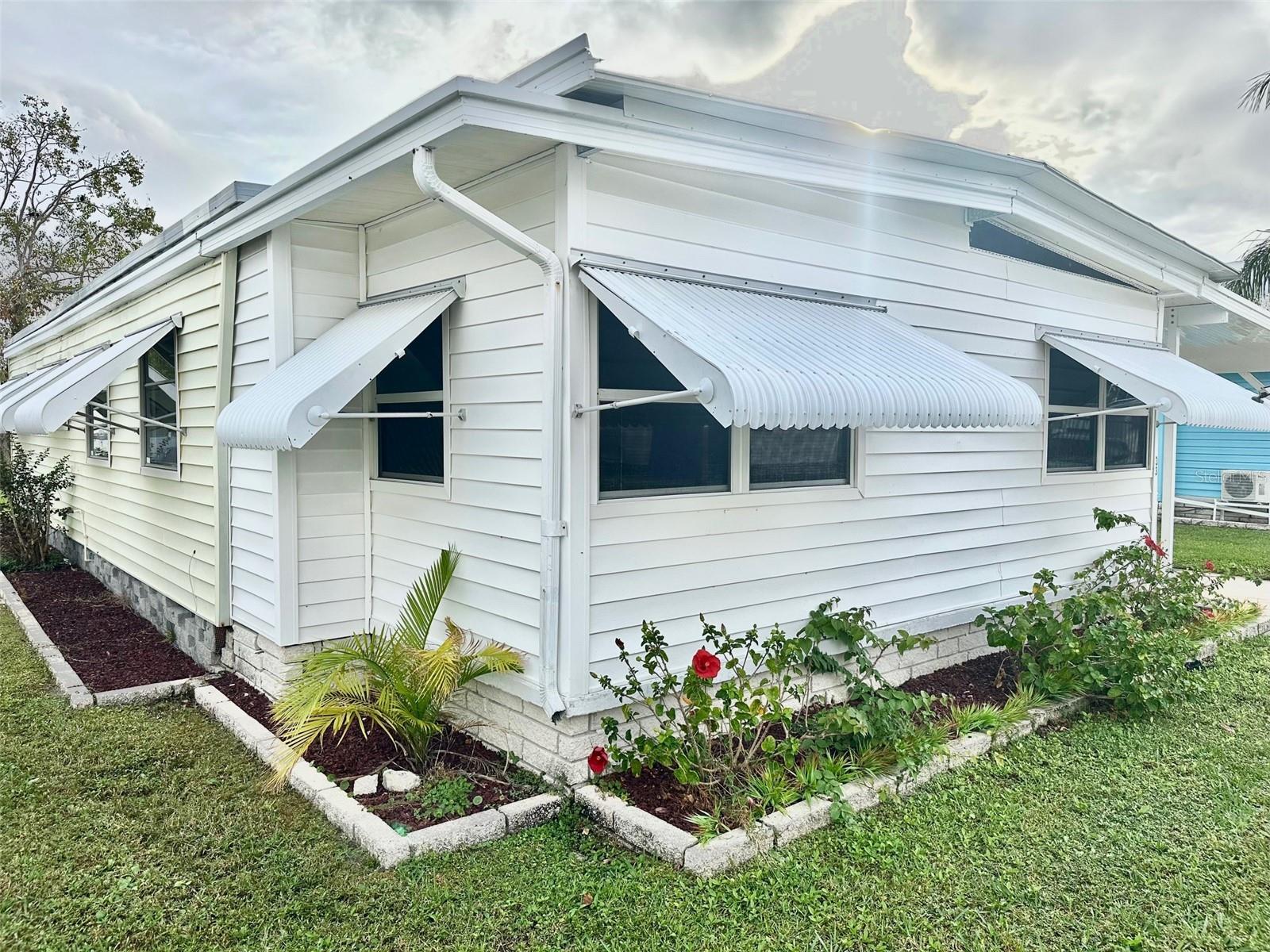 New Super Low Price! Hurry to see this inviting 2 bedroom, 2 bath, 1164 sq. ft. doublewide, with front Florida Room & Sunny Screen Room to enjoy! All new Decorator Laminate Flooring, and Interior Paint! Insulated Double Roof Over 2017, Central Air Heat Unit 2017, and Water Heater 2023. Convenient inside Washer/Dryer, with lots of extra storage! Spacious Master Bedroom Suite, with delightful dressing area, and 2 wonderful closets. Updated Carport, with parking for up to 2 cars. Come see this popular 55+, Resident Owned fun & enjoyable Pool Community! Located close to golf courses, beaches, airports, shopping, VA Medical, and all you would want! Small pet ok! Cash only! Now Asking $106,900., includes the share! Low $210. mo. maintenance fee!