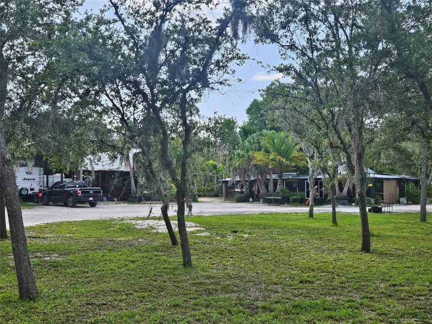 5 acres of high and dry, impacted land. With over 300 manicured fruit and palm trees. 2 electrical boxes have been impacted on site, 3 RV pads, 2 septic systems, well water system, the list of trees on site include figs, mangos, avocados, Lemons, limes, key limes, oranges, tangerines, pomelo, jackfruit, starfruit, persimmons, pomegranates, bananas, dragon fruit, loquat, papayas, peaches, plums, cherries, guava, blackberries, palm trees, limequat, and kumquat. Property is high and dry. This property is an oasis and is easy to access. 5 acres of pristine manicured cleared land with fruit, palms, RV pads, septic systems, and electric.