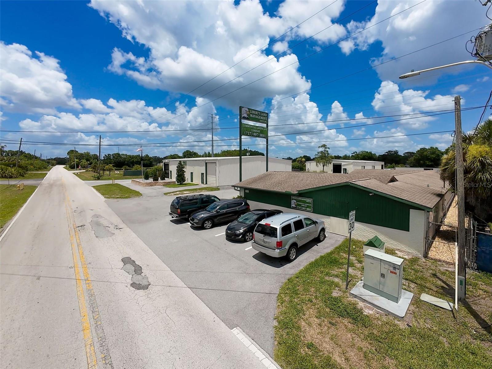 Commercial Complex under C2 zoning in New Port Richey, West Pasco County Fl. This property offers nearly 22000 square feet of space inside 4 structures.
Building 1 is 4248 square feet of finished flex space, currently configured as offices; complete with reception area, private executive offices, storage space, conference room, 3 bathrooms and mechanical/electronic closet. Recent paint inside and out, remodeled baths, durable vinyl laminate flooring and new HVAC. Ample street parking as well as on building side.
Building 2 is 6300 square feet, with 5500 square feet of insulated warehouse space accessed by 3 overhead doors, two electric operated, and 800 square feet of showroom space (creating a loft for more storage). Bathroom on site, glass door entry into showroom.
Building 3 is 9100 square feet warehouse space with 6 overhead doors, 4 electric operators, with small office & loft storage, wash rack area and bay storage at rear. Semi dip-ramp and loading dock.
Building 4 is storage shed with new roof, 1600 square feet with sliding door.
Southeast of property has large 1/3 acre asphalt paved parking area for large equipment, or potential for additional structure.
For an owner/user, the property offers versatile solutions to all logistic needs; a rare find in the direct West Pasco market area.
For the Investor, the property is currently leased to single tenant until March 2025. It is perfect for multi-tenant occupancy and can generate a strong CAP rate and generous ROI.