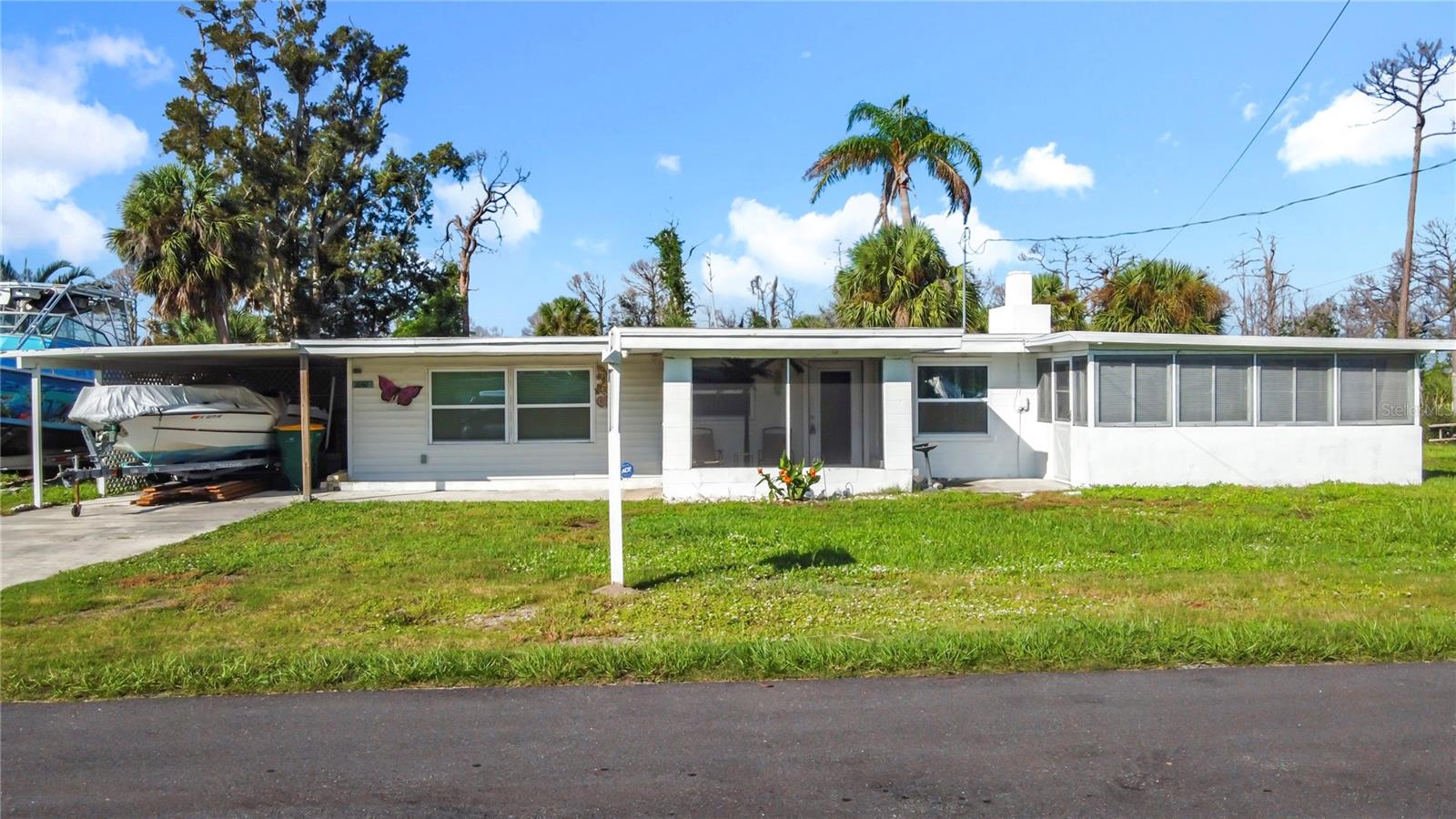 Welcome to your slice of Florida living! This charming 2-bedroom, 2-bath home offers flexible single-level living with thoughtful updates and plenty of space for guests — it can comfortably sleep 6–8. Nestled on a quiet dead-end street with no HOA, no CDD, and no deed restrictions, you’ll enjoy the freedom to bring your boat or RV and park right at home. Best of all, you can have your boat in the water in just minutes with Ainger Creek access nearby, or step out back and explore the trails of Cedar Point Environmental Park with Lemon Bay just beyond.
Inside, the home is move-in ready with a granite and stainless kitchen featuring modern gray cabinetry, sleek updated baths (including a master shower with dual shower heads), and the convenience of an inside washer and dryer. Entertain with ease in the screened lanai, enclosed Florida party room, or large outdoor spaces complete with an outdoor shower. There’s also an office/den with private entrance, a decorative fireplace, and 4 efficient WiFi-enabled mini-split systems for year-round comfort. Other improvements include updated electrical, plumbing, and roof (all permitted). Two sheds, a carport, and two lanais provide excellent storage and flexibility. The neighborhood is warm and welcoming — a close-knit community where neighbors look out for one another. School is close enough to walk, bike or drive to school with ease as you're minutes from Lemon Bay High School and minutes to shopping, dining, and Gulf beaches. If you’re seeking a turnkey coastal home with personality, upgrades, and room for all your Florida toys, this is it. Come see today and start living the relaxed Englewood lifestyle!