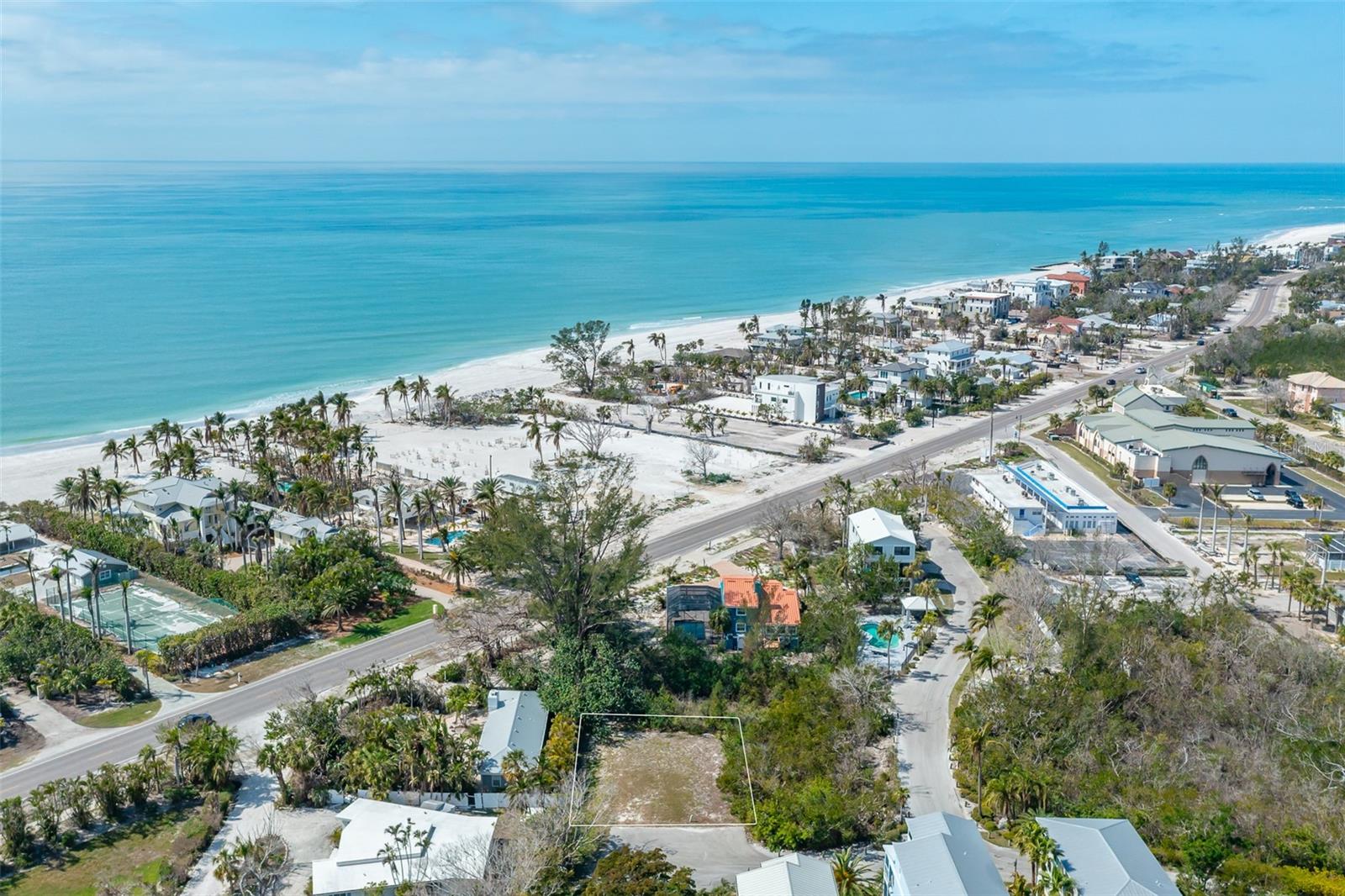 Discover your boater's paradise on Longboat Key! This is a rare opportunity to build your dream oasis on the last available vacant lot in the exclusive, gated Laguna Yacht Village community of only 9 plots, with 8 beautifully built homes already in place. Nestled on the bay side, this prime lot offers a blank canvas for a custom home in a serene setting. Enjoy resort-style amenities including a community pool, a scenic walkway to a deeded boat slip, and quiet public beach access on the Gulf side. The community, only mildly affected by recent storms, offers a peaceful lifestyle while still catering to boating enthusiasts. Build your personal retreat where luxury and leisure meet!