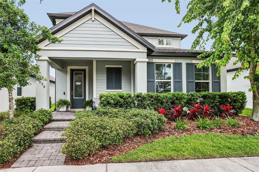 Beautifully upgraded two-story home in Starkey Ranch, offering 2,865 sq ft with 4 bedrooms, 3.5 baths, a large upstairs game room with balcony, and a 2-car garage. This Mi Homes Wellington floor plan features durable Hardie board siding, a paver driveway and walkway, manicured landscaping, and a welcoming front porch with pond and conservation views across the street.  Inside, the open-concept layout is highlighted by luxury vinyl plank flooring throughout the main living areas, 8-foot doors on the first floor, and a clean, neutral palette. The kitchen is designed for both everyday living and entertaining, with 42" maple cabinetry, quartz countertops, tile backsplash, stainless steel GE appliances including a gas range, and a large island with seating and farmhouse sink. The adjoining dining and living areas flow seamlessly, anchored by a custom shiplap feature wall with built-in fireplace.  The main-level owner’s suite offers a tray ceiling, walk-in closet with built-ins, and an ensuite bath featuring dual vanities and an oversized walk-in shower. A half bath and a functional laundry room with cabinetry and folding space complete the first floor.  Upstairs, the expansive game room provides flexible living space and opens to a private balcony. One secondary bedroom includes an ensuite bath and walk-in closet, while two additional bedrooms share a full bath. Outdoor living includes a covered patio and a fenced backyard. Additional features include hurricane shutters, tankless gas water heater, water softener loop, and epoxy-coated garage floors. Located in the highly sought-after Starkey Ranch community, residents enjoy access to top-rated K–8 schools, multiple pools, parks, playgrounds, dog parks, trails, and a community center. Conveniently close to shopping, dining, beaches, and Tampa international airport.