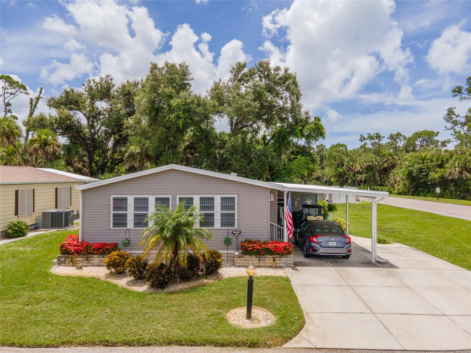 Welcome to carefree coastal living, just MINUTES FROM THE BEACH, in the highly sought-after 55+ gated community of TANGERINE WOODS—where lifestyle meets location! Nestled on a spacious CORNER LOT, this beautifully maintained double-wide manufactured home offers the perfect blend of comfort, convenience, and peace of mind. ***With a NEW CENTRAL A/C SYSTEM, CARPORT, HURRICANE SHUTTERS, AND extra wide driveway you can move in with confidence and start enjoying your Florida lifestyle right away. ~~~Step inside to discover a bright and airy LIVING ROOM, ideal for entertaining guests or relaxing with your favorite book. Need extra space? The versatile FAMILY ROOM is perfect for a home office, hobby area, or simply more room to unwind. Whip up delicious meals in the well-equipped kitchen, complete with ample cabinetry and a convenient BREAKFAST BAR for casual dining, while a separate dining area offers space for more formal meals or game nights. ***At the end of a sun-soaked day, retreat to your serene PRIMARY SUITE, featuring an HANDICAP ACCESSIBLE EN-SUITE BATH for ultimate privacy and comfort. A SECOND BEDROOM AND FULL BATH welcome visiting friends and family, while the utility room beyond the carport makes laundry day a breeze. This home offers abundant storage with two spacious walk-in closets, a convenient linen closet, and plenty of cabinetry in both the kitchen and family rooms to keep everything organized and within reach. ~~~Tangerine Woods is brimming with resort-style amenities—take a refreshing dip in the HEATED POOL, challenge friends to a game of PICKLEBALL OR TENNIS, stay fit in the community gym, or join in the fun at the clubhouse, shuffleboard courts, and regular social events. Plus, your HOA includes cable and internet, adding even more value to your new lifestyle. ***Located just MINUTES FROM HISTORIC DEARBORN STREET, you’ll love exploring local farmers markets, boutique shops, waterfront dining, and vibrant community events. Spend your days sunbathing on Manasota Key or Englewood Beach, or enjoying nearby golf courses, fishing charters, and boating adventures. You're also close to DOWNTOWN VENICE AND THE NEW WELLEN PARK for even more entertainment and dining options! ~~~Don’t miss your chance to own a slice of paradise—schedule your private tour today and start living the Florida lifestyle you deserve!