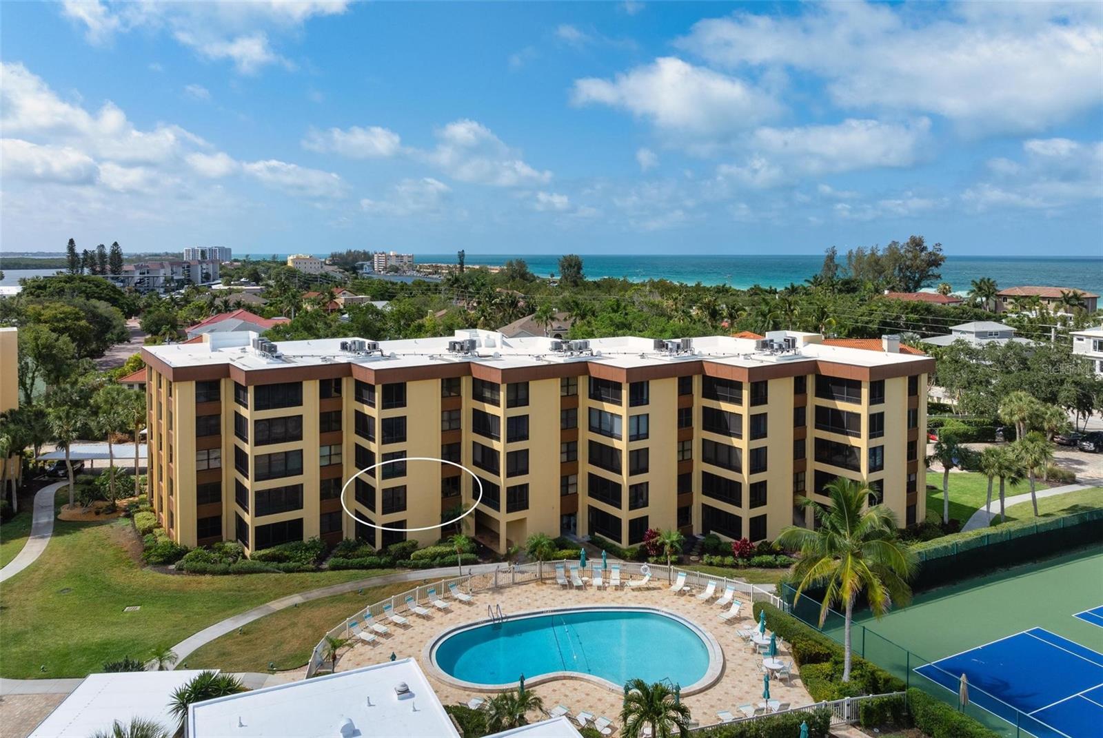 One or more photo(s) has been virtually staged. Welcome to Island Reef, an amenity rich Gulf to Bay resort where living the dream meets reality. Located on the tranquil southern end of Siesta Key you are just steps away from enjoying boating activities on the Intercoastal, a day at leisure on the beach or taking in a beautiful sunset over the Gulf. Come see this BAYSIDE condo that has undergone a remodel to include raising the ceiling in the kitchen and dining room areas, retexturizing all ceilings in the condo and installing plank tile flooring in the dining, living and both bedrooms. The kitchen features solid wood cabinetry to the ceiling, granite countertops, stainless steel appliances and an enlarged pass through to the dining area. The final piece of the remodel includes a customized office nook with a built-in desk with overhead and adjoining storage cabinets. Meticulously cared for this light and bright condo with white/off white colors throughout provides a neutral pallet for all your furniture and decorating ideas. The spacious Primary Suite features sliders to the screened and glass enclosed lanai, a large walk-in closet, bathroom with dual sinks and a walk-in shower. A generous-sized guest bedroom with shower and bath is ideal for family or guests. With its open floor plan the focal point of this condo is the spacious living/dining room which flows into the east facing tiled screened lanai; a perfect place to enjoy the dawn of a new day or a shady respite in the afternoon. For your peace of mind, the A/C unit was replaced in May 2024 and the hot water heater in 2020. At Island Reef the vacation never ends with your choice of two heated pools, a remodeled clubhouse, fitness room, newly resurfaced lighted tennis and pickleball courts, barbeque patios with gas grills, deeded beach access, boat docks, fishing, a place to store your bike or kayaks and so much more. In true island fashion you can walk to the front entrance of the complex, hop aboard the free classic style Breeze Trolley and enjoy a fun and relaxing day venturing out to a wide variety of restaurants, bars, gourmet grocery stores and shops on the Siesta Key while your car is parked in the shade of your deeded carport space. If you’re looking for a seasonal refuge from our Northern winters, a full time residence or an investment with attractive rental possibilities you can’t go wrong at Island Reef.