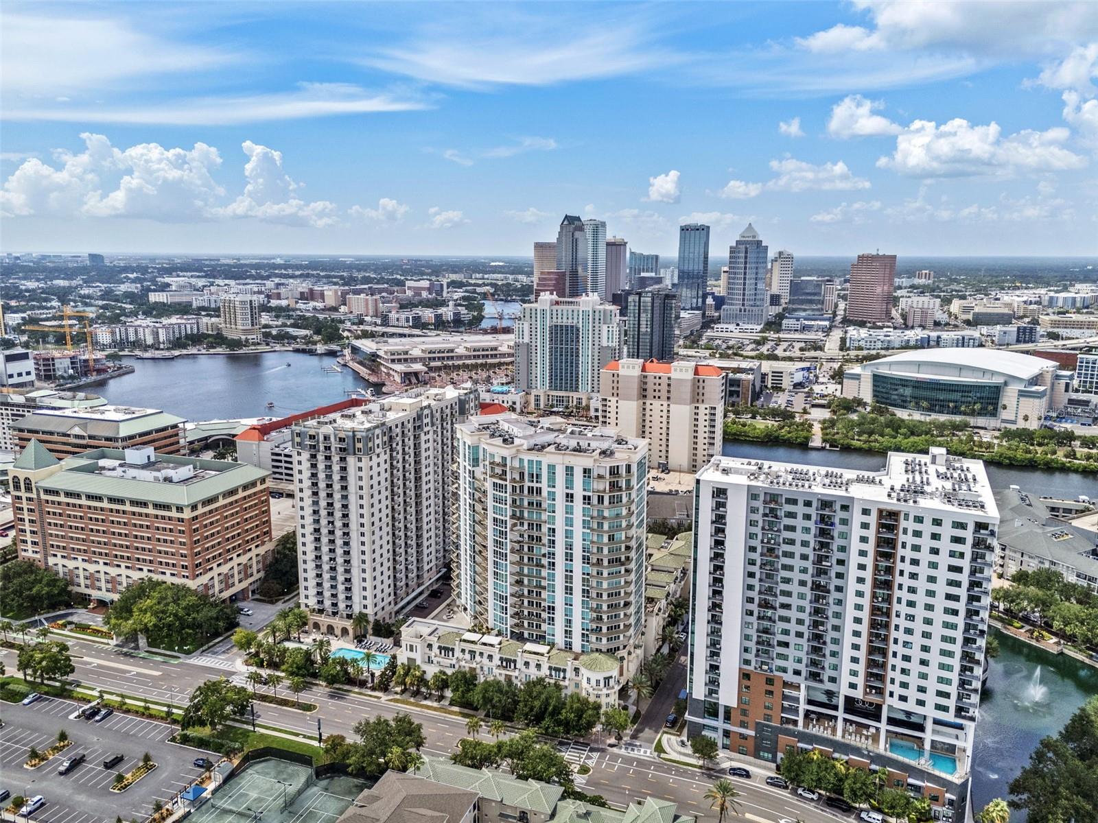 Discover sophisticated urban living in this exceptional residence at The Plaza on Harbour Island offering 2 suites and a 3rd bedroom or office space. Your private elevator landing opens into a luxurious foyer, distinguished by a tray ceiling and gleaming hardwood flooring that extends throughout the open floor plan. The main living area is bright and bathed in natural light, thanks to floor-to-ceiling windows and glass sliding doors that create a seamless indoor-outdoor feel. An expansive gourmet kitchen is exquisitely updated with beautiful quartzite counters that follow up the backsplash, complimented with beautiful cabinetry. The primary bedroom is a true retreat, offering panoramic floor-to-ceiling corner windows, elegant crown molding, and two closets. Completing the suite with the lavish bathroom was fully remodeled in 2021 featuring stunning vanities, a frameless glass walk-in shower, and a deep soaking tub. The split floor plan ensures privacy for the guest suite, which includes Southwest views over the oversized windows, crown molding, and a large walk-in closet. A versatile third room, ideal for an office or additional bedroom, is enclosed by glass French doors and features an en-suite half bathroom. Other key features include modern fixtures, window treatments, walk in pantry, built out closets, 2024 tankless water heater, two parking spaces, and storage locker. Step outside onto the spacious covered balcony to enjoy a relaxing sitting area, and scenic South facing views over Harbour Island with cruise ships passing by. This residence is complemented by The Plaza’s full service amenities, including on-site valet parking, a concierge desk, various elegant lobby spaces, a well-equipped fitness center with a private treatment room and sauna, multiple business and meeting rooms, a theater and games room, a resort-style heated pool and spa with shaded cabanas, and a covered grilling station. With direct access to The Tampa River Walk, this building is pedestrian friendly to all the dining and entertainment options that the Water Street District, Amalie Arena and Downtown Tampa while also located in the top rated Gorrie, Wilson, Plant school district.