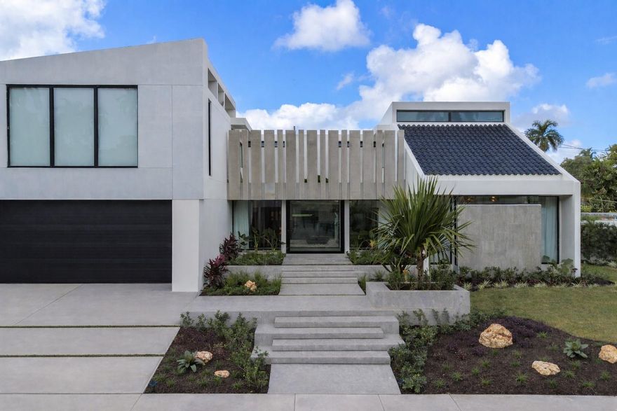 Welcome to a one-of-a-kind, fully remodeled luxury residence designed for modern living, comfort, and effortless entertaining. Located in the highly sought-after community of Extensión Santa María, this architectural home blends sleek contemporary design with warmth, functionality, and smart technology.

From the moment you arrive, the striking façade and tropical landscaping create a powerful first impression. Inside, a dramatic glass-enclosed foyer with a tranquil indoor garden welcomes you with natural light and a sense of calm that sets the tone for the entire home.

At the heart of the property is a stunning Italian-designed kitchen by Formato, featuring quartz countertops, sleek black cabinetry, and high-end stainless steel appliances. The kitchen seamlessly connects to a stylish wine and bar area with outdoor access—perfect for entertaining and everyday enjoyment.

The home offers 6 spacious bedrooms, including a versatile downstairs suite with private bathroom ideal for guests, a gym, or home office. Upstairs, the oversized primary suite serves as a private retreat with a spa-inspired bathroom, elegant vanity area, expansive shower, and two custom walk-in closets designed for boutique-style organization.

This smart home is equipped with architect-designed LED lighting, integrated sound system, new security windows, inverter air conditioning (3 central units + 7 mini-splits), a 24 kW backup generator, and a 1,200-gallon water cistern for peace of mind and efficiency.

Outdoor living is just as impressive, featuring lush tropical landscaping, a fun upstairs terrace, parking for five vehicles, and a private convertible basketball/pickleball court—perfect for enjoying the Puerto Rico lifestyle year-round.

This residence was thoughtfully designed for comfort, efficiency, and elevated living—a rare opportunity in San Juan.