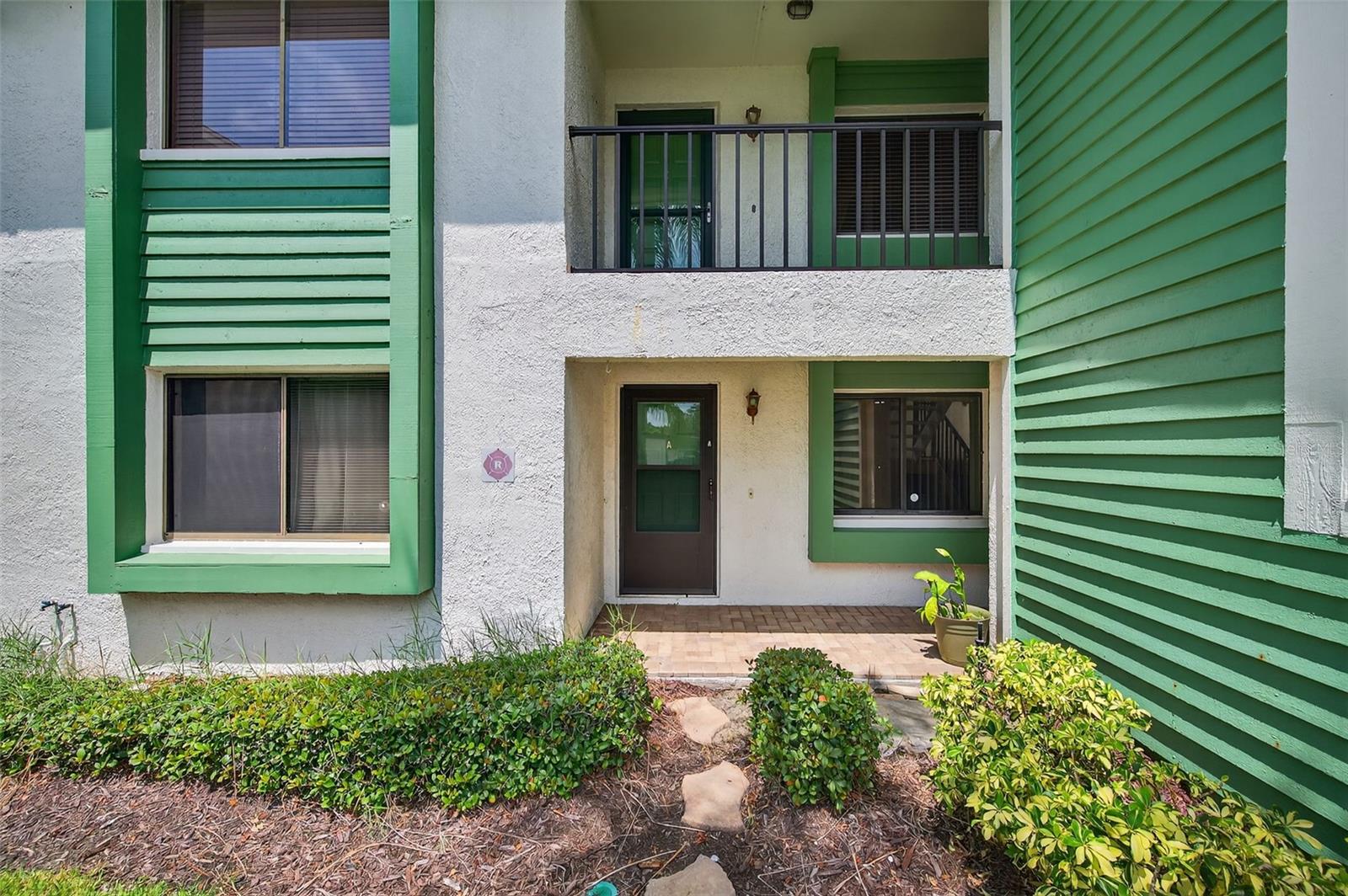 Welcome home to the highly desired community of Village on the Green. Purchase with peace of mind! This property has an elevation of over 70'. It is in Flood Zone X and a Non Evacuation Zone. The reserves are fully funded! As a two-story building, it is exempt from Milestone Inspections, impacting condos three stories and higher. Dive into paradise with this stunning 1st floor, two-bedroom, two-bath condo, perfectly nestled in a vibrant 55+ community! Your gorgeous condo has an updated eat in-kitchen with beautiful tile flooring. The living areas and bedrooms feature handsome LVT wood-look floors. The living area is large and includes a dining area adjacent to the living room. From the living room you have a large, secluded Florida room, perfect for your morning coffee, afternoon reading and evening refreshments. The primary suite is large with a walk in closet and en-suite bathroom with a walk in shower. The guest bedroom can also be used as an office or den. The condo has it's own laundry room inside the unit with shelves and room for storage. The perks don't stop there! This community is a lifestyle, not just a location. Enjoy a sparkling pool, a clubhouse with a fitness center, library, card room and banquet room. Outside you will find the shuffleboard courts and community picnic area complete with gas grills for residence use. The clubhouse offers card playing and board game groups of all kinds as well as a shuffleboard group that meets weekly in the fall through the spring. Additionally there are regular community events throughout the year. Your condo fees include, water, sewer, trash, cable tv and internet in addition to all of the exterior maintenance and common area maintenance. And the best part, you're just minutes away from the heart of vibrant Downtown Dunedin, with its charming shops, delectable dining, and lively entertainment. Plus, you’re close to Honeymoon Island, Caladesi Island and more of Florida’s best beaches and fun activities. This condo offers you peace of mind and fun in the sunshine. Don’t just dream of the Florida lifestyle – live it!