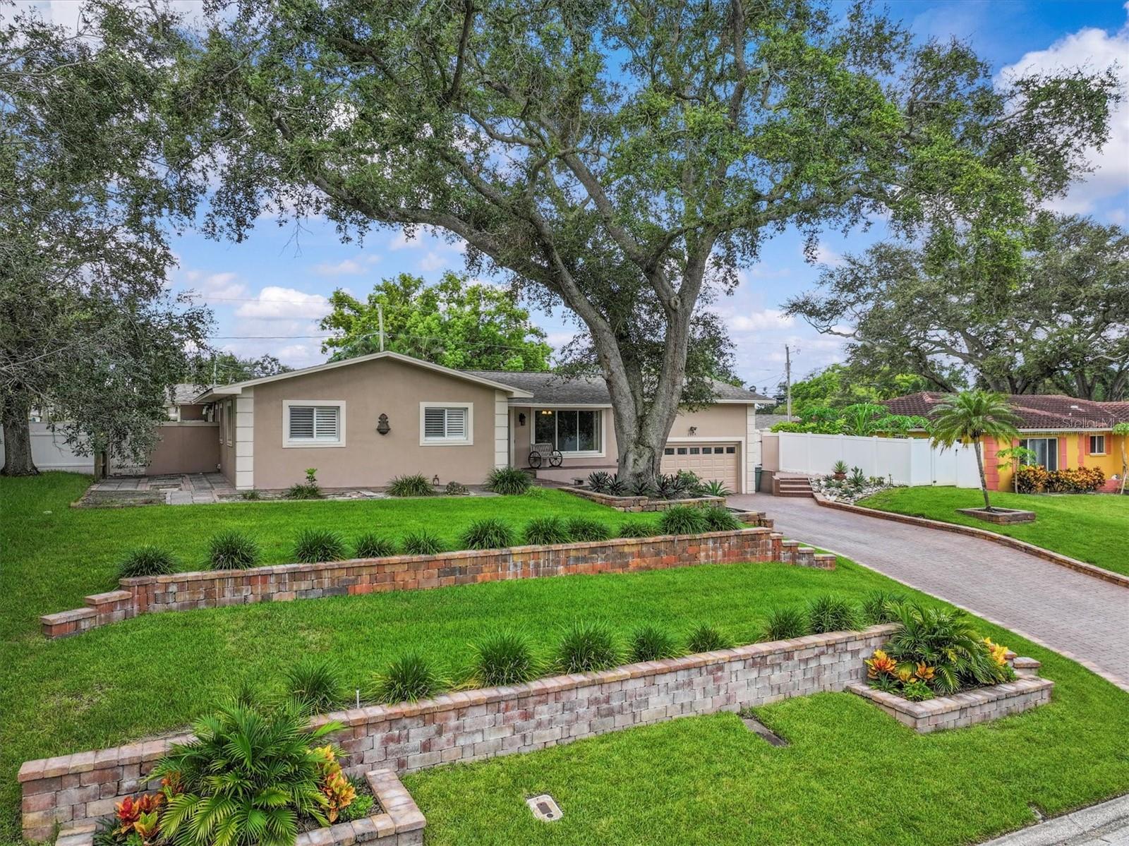 Welcome to this beautifully maintained home in the sought-after golf course community of Fairway Estates—high and dry in an X flood zone with no history of flooding! This inviting residence features a light-filled great room layout with elegant travertine floors, a breakfast bar, and a built-in coffee bar, perfect for relaxed Florida living. Enjoy stylish upgrades including chateau-style entry doors, plantation shutters throughout, designer lighting, and an updated kitchen with modern cabinets, hardware, pendant lighting, and a statement range hood. Ideal for entertaining, three sets of sliding glass doors lead to a spacious, enclosed travertine patio and pool deck, creating a seamless indoor-outdoor living experience. This thoughtfully designed split floor plan offers 3 bedrooms, 3 full baths, and a versatile bonus room—perfect as an office, gym, or nursery—connected to the primary suite. The luxurious primary suite includes two separate ensuite bathrooms: one with a jetted tub, sauna, and separate shower with direct access to the pool; the second bath features a step-in shower. Great for privacy! The oversized garage is a dream come true—tall ceilings provide room for storage, a workshop, or even your golf cart, which you're welcome to use on neighborhood streets. Golf cart approved roads to ride to Downtown Dunedin. Less than a mile to the Dunedin Causeway and 2 miles to Honeymoon Island. Located just a short walk from the Dunedin Golf Club, Highland House restaurant & bar. Minutes to Hammock Park, the Dunedin Community Center, the Fine Art Center, and the Pinellas Trail—you’ll love living in the heart of Delightful Dunedin, where every day feels like a vacation.