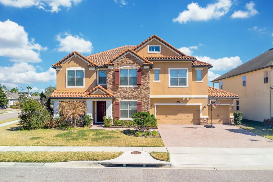 Welcome to a home that truly has it all. Located in the desirable gated community of Astor Grande at Lake Forest, this impressive residence offers nearly 5,000 square feet of beautifully designed living space, combining luxury, comfort, and exceptional spaces for entertaining.
Set on a ¼-acre corner lot and topped with an elegant tile roof, the home welcomes you with a bright and inviting presence. Inside, you’ll find a spacious and open floor plan with wood-look tile flooring throughout the entire first floor and crown molding that adds an elevated touch throughout the home.
The welcoming entry is flanked by a formal dining room on one side and a private office with French doors on the other, perfect for working from home. As you continue inside, the home opens into a huge family room filled with natural light, seamlessly connected to the gourmet kitchen. Designed with both style and functionality in mind, the kitchen features state-of-the-art appliances, double ovens, and a large center island, creating the perfect hub for gatherings and everyday living.
Step outside to your private backyard retreat featuring a huge covered porch overlooking the pool and peaceful pond, creating the perfect setting for relaxing evenings or entertaining guests. The large pool and spa, fenced yard, and tranquil water views make this outdoor space just as impressive as the interior.
The layout is ideal for multi-generational living and hosting guests. A full bedroom with en-suite bathroom is conveniently located on the first floor, while upstairs you'll find four additional spacious bedrooms, including one with its own private bath.
Upstairs living truly shines with an enormous loft complete with a wet bar, offering plenty of room for a pool table, game area, or lounge space. Just off the loft is a bonus room currently used as a home movie theater, which opens to a massive balcony—an incredible spot to unwind or take in the views.
The owner’s suite is also located upstairs and serves as a private retreat with generous proportions, dual walk-in closets, and a spacious en-suite bath.
The home also offers an extended garage configuration with space for up to four vehicles, thanks to one bay that extends deeper—perfect for additional vehicles, storage, or a workshop area.
Located just minutes from I-4, 417, and 429, Astor Grande at Lake Forest offers excellent connectivity while still providing the privacy and charm of a gated community. Enjoy easy access to shopping, dining, entertainment, and Seminole County’s top-rated schools.
This is the kind of home that rarely comes available—spacious, elegant, and designed for both everyday comfort and unforgettable gatherings.