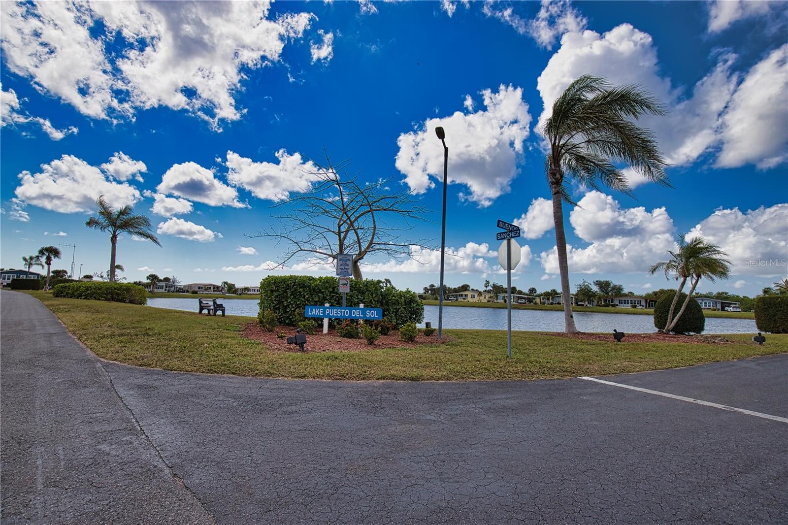 Discover Florida living at its absolute finest! This enchanting home is nestled at the back of the park, overlooking one of our most picturesque lakes. As you approach, you'll be greeted by lush, vibrant landscaping that sets the tone for the beauty that awaits inside. Step onto the spacious lanai, adorned with elegant ceramic tile flooring, which seamlessly connects to an oversized shed—offering generous space for a laundry area and a tool shed. Inside, the open-concept kitchen, dining room, and living room create a welcoming atmosphere perfect for entertaining family and friends. From the living room, you'll be drawn into the impressively large Florida Room. Bathed in natural light from its extra-large windows, this serene space boasts ceramic tile floors and sheetrock walls, providing breathtaking views of the tranquil lake. Whether hosting gatherings or enjoying a quiet moment, this room is an idyllic retreat. The primary bedroom offers a serene escape, featuring an ensuite bathroom complete with a stylish tile floor, a spacious walk-in closet, and a luxurious walk-in shower. Your guests will enjoy unparalleled comfort in the second bedroom, conveniently located across the hall from a well-appointed bathroom. Since its purchase in 2001, this home has undergone numerous enhancements. Notable updates include the stunning Florida Room (214 sq ft) with its oversized windows, a beautifully tiled lanai (144 sq ft), and a functional tool shed (120 sq ft). Enjoy peace of mind with double-glazed windows throughout, and a durable roof featuring all-weather roofing that includes a transferable lifetime warranty. La Casa boasts 974 homes nestled among a variety of native trees with spacious common grounds surrounding our eight lakes. The ultimate lifestyle on Florida’s Gulf Coast is located between Sarasota and Fort Myers and is a boaters dream with access to the Gulf of Mexico. It is convenient for shopping, sightseeing, golfing, fishing, and boating, as well as all the culture and elegance the Southwest Florida area is noted for. Residents and visitors enjoy the warmth of Southwest Florida winters in a relaxed and unhurried environment far removed from the hustle of Florida’s east coast. You’ll be surrounded by hundreds of palms reaching for the sky and beautiful mature lush landscaping which demonstrates the utmost level of care our property receives from residents and management. La Casa may have the best pools in the area. Our extremely large, 40 X 60-foot swimming pool is our crown jewel and that is kept at a perfect 87 degrees. Our smaller 20 x 40 pool is quietly nestled between the clubhouse and the Activity Building. Both pools have adjacent hot tubs which are ideal for soaking muscles that are tired from golfing or tennis. Wireless Internet (Wi-Fi) is available at the Clubhouse, Activity Building, and Recreation Hall area where these pools & spas are located, so you can catch some rays while you catch up on your email! Sound enticing? La Casa is a friendly, family community. You will be away from the hustle and bustle except when you want to be part of it. When you leave our gates, North Port is only 1.5 miles from the city center, where you will find every kind of retail store and service you could need. Come for a visit to this self-contained oasis and see for yourself why La Casa is the ultimate destination for both snowbirds and year-round.