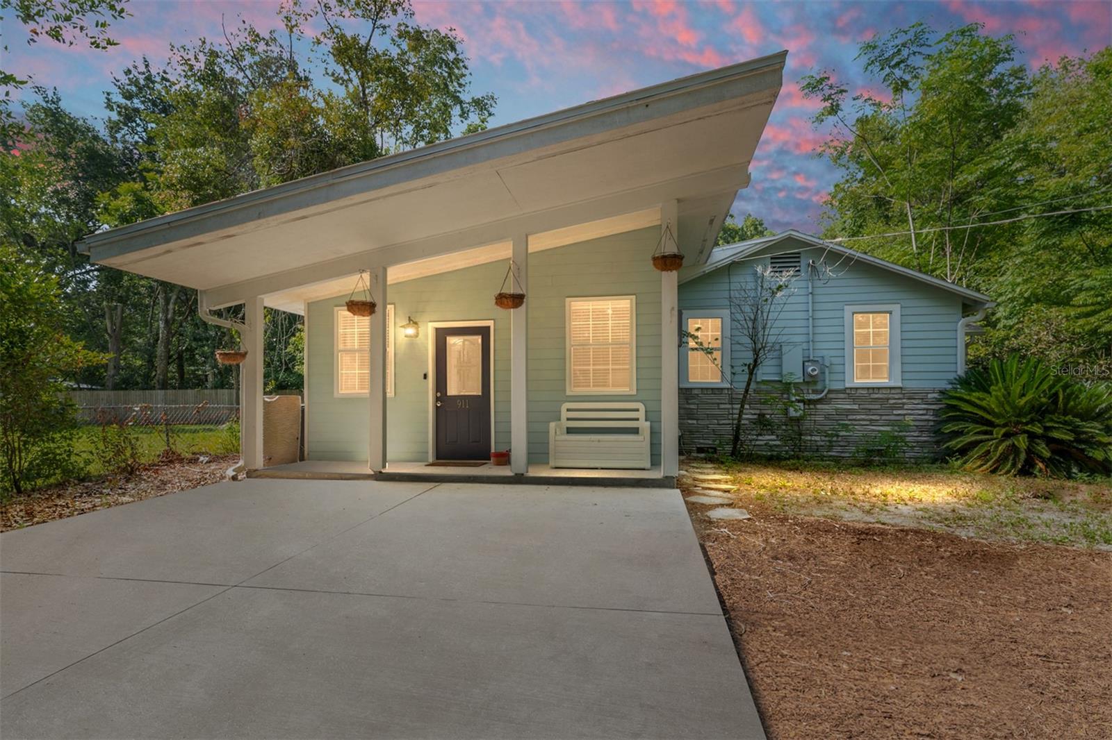 Here is a harming in-town cottage ready for you today! Nestled between 13th Street and the lively 6th Street corridor, this move-in-ready gem keeps you a bicycle ride from UF, downtown dining, and shopping, not to mention easy access to SFC and the airport. Inside, original hardwood floors gleam, paired with a chef-friendly gas range and oversized pantry. Double-pane insulated windows, updated PVC plumbing, 200-amp electric, a 2015 architectural-shingle roof, and a tankless water heater deliver peace of mind (and insurance savings). The flexible layout offers three true bedrooms, a dedicated office, a sun-filled Florida room, and a private-entry bonus room with its own A/C—perfect for a studio, guest suite, or rental. An indoor laundry room (washer & dryer stay) adds everyday convenience. Step outside to your personal half-acre park: a fully fenced 0.52-acre backyard with a cafe-style patio, evening firepit, and garden beds ready for planting. No HOA, a circular driveway with plenty of parking, and endless possibilities—schedule your tour and fall in love!