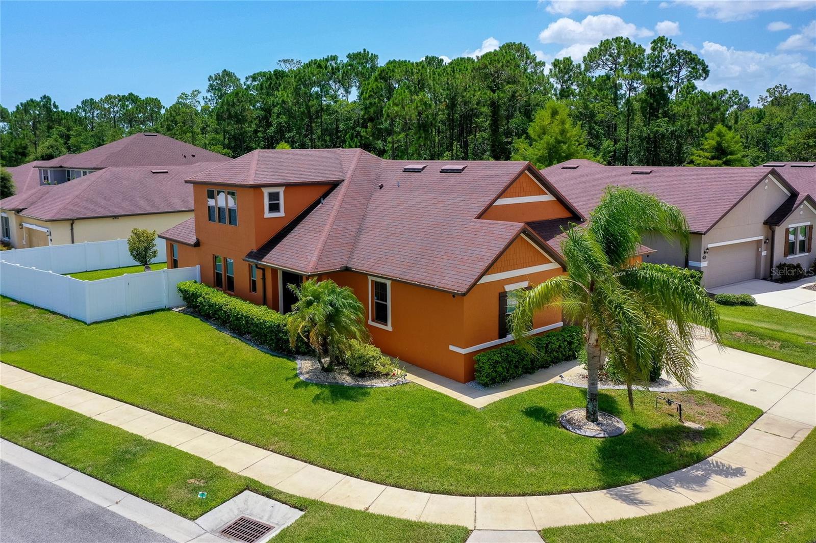This expansive 4-bedroom, 4-bathroom, 2-story home in the desirable Tuscany Woods community offers 2,700 square feet of well-designed living space on an oversized corner lot. Thoughtfully maintained and brimming with functional upgrades, this home includes two ensuite bedrooms, a spacious upstairs bonus room with its own full bath, and an open-concept layout ideal for modern living. The kitchen is a standout with granite countertops, rich wood cabinetry, stainless steel appliances, a center island, and both a cooktop and separate double ovens -perfect for everyday meals or entertaining. The living and dining areas flow seamlessly, anchored by large windows, luxury vinyl plank flooring, and direct access to a screened lanai overlooking the fully fenced backyard with vinyl privacy fencing - ideal for kids and pets to play safely. The primary suite features a spacious walk-in closet, and a well-appointed ensuite with double sink vanity and a walk-in shower. Three additional downstairs bedrooms, one with its own full ensuite, offer flexibility for family, guests, or a home office. The generous upstairs bonus room with full bathroom can be used as an additional bedroom, game room, or home gym, tailor it to fit your lifestyle. Additional highlights include a dedicated laundry room, ceiling fans throughout, and a 2-car garage with epoxy-style flooring. The pavered backyard patio and screened lanai are ideal for relaxing or entertaining year-round. Located on an oversized corner lot, this home offers access to Tuscany Woods amenities including a community pool, clubhouse, and playground. Fantastic location with easy access to I-95, Daytona International Speedway, Tanger Outlets, shopping, dining, and an array of entertainment options. All information recorded in the MLS is intended to be accurate but cannot be guaranteed.