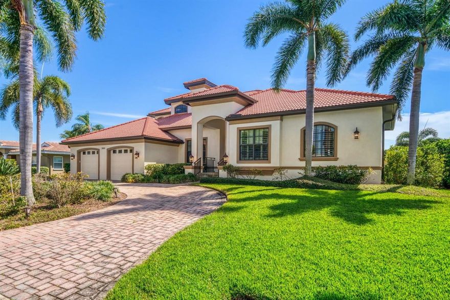 This Waterfront Home is located in the community of Venetian Isle. Southern Comfort is built into the design of this Custom home. The pavered circular drive sets the ambience of the many tasteful details. Welcome, step through the beautiful double doors of wood, glass and iron decorations into the entry hall. The living room and dining room with wood floors, high ceilings and crown molding are open for entertainment. Entrance to the left leads to the magnificent kitchen with prep island and an extravagant granite counter top for sitting or serving. Also offers a walk in pantry and a full laundry room with more storage cabinets. This great room includes a dinette area, a wet bar with Icemaker and leaded glass display cabinets. The entire rear wall is finished with stunning wood cabinets and shelves to hold the entertainment electronics. The half/bath is not only convenient but lovely with special lighting and details. The Spacious Master Bedroom Wing with ensuite offers two walk in closets, double vanities a large, glass enclosed shower, a separate soaking tub, a bidet and toilet. Each room on the first floor allows access to the rear porch, Outdoor Kitchen, Pool and Dock. Take the stairs or ELEVATOR to the second floor. A morning kitchen with built in cabinet, microwave and refrigerator is located in the hall. There is a Second Master with ensuite. Two more spacious bedrooms share a full bath. Both bedrooms have access to the Covered Verandah with spectacular Waterviews.