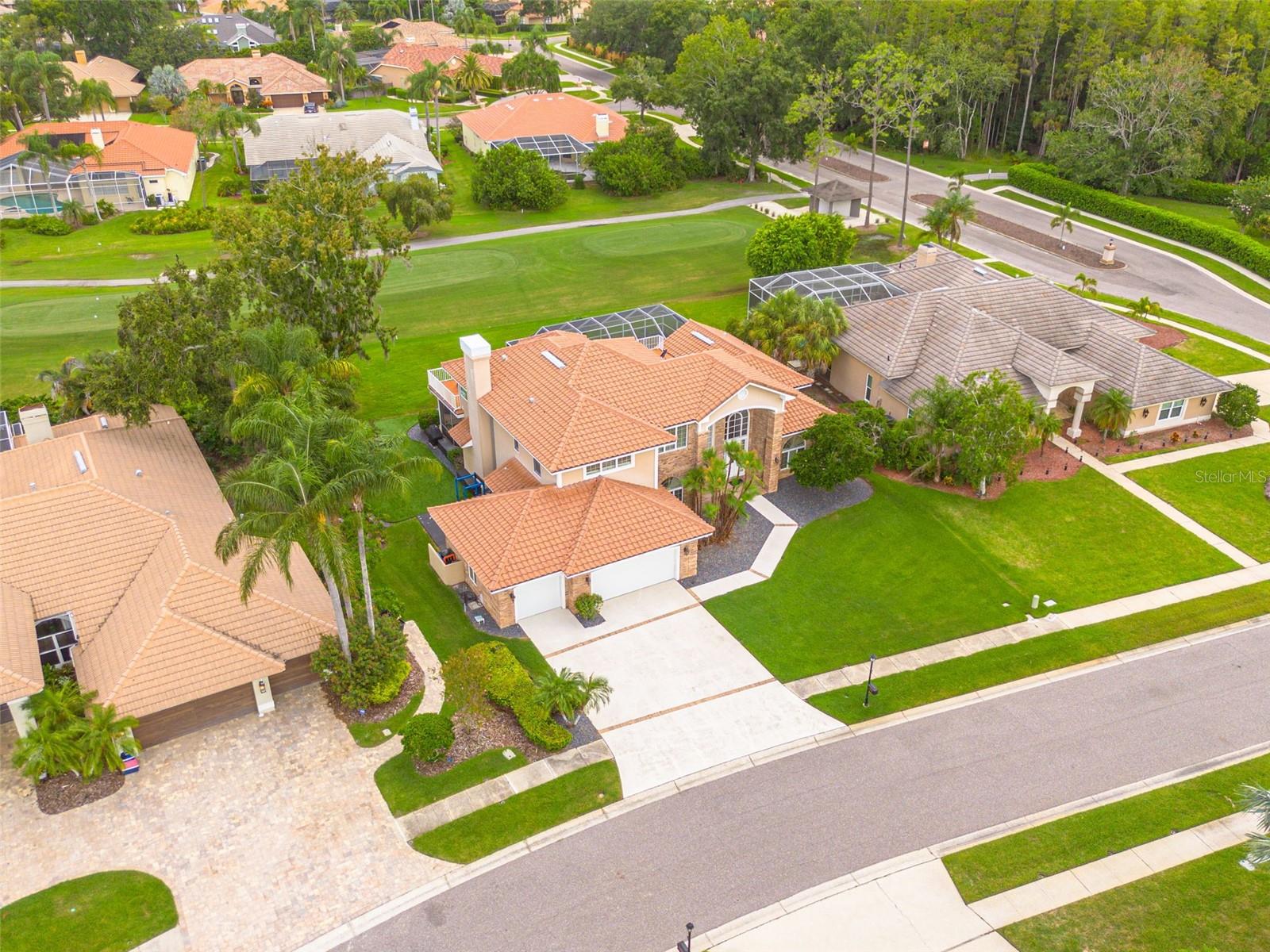 Set within a private, gated enclave of Aberdeen within the confines of the exclusive Ardea Country Club, this Mediterranean-inspired pool home delivers resort-style living with all the security of a gated community. The home sits directly on the 17th tee box of the North Course, offering unobstructed golf views and lush green surroundings.
From the moment you arrive, the red barrel-tile roof and brick-and-stone façade make a strong first impression. Step inside to discover soaring ceilings, plantation shutters and rich hardwood floors. The open floor plan flows effortlessly from the great room, with its brick fireplace and custom built-ins, to the updated kitchen featuring dark wood cabinetry, a granite island and stainless appliances. Formal and casual dining areas offer flexibility for everyday meals or entertaining.
The expansive owner’s suite is a true retreat. In addition to a sitting area with built-in shelving and a luxe bath with dual vanities and a soaking tub, the suite opens onto a private deck/lounging area, a perfect spot for morning coffee overlooking the fairway. Additional bedrooms and baths are generous and tastefully appointed.
Outdoor living is exceptional: a covered lanai with ceiling fans and outdoor TVs connects to a screened pool and paver deck. Beyond the screen, enjoy an artificial putting surface for practicing your short game and a paver patio with Adirondack-style seating that frames sweeping golf-course views. Mature trees and hedges provide privacy, yet the vistas remain open and serene.
This property combines the prestige of Ardea Country Club, the security of a gated neighborhood, and luxurious indoor/outdoor spaces plus unique perks like your own putting green. A truly rare opportunity for those seeking an elevated lifestyle on one of Ardea’s most desirable homesites.
Ardea Golf and Country Club (within the confines of East Lake Woodlands)...home to 2 championship golf course, Pickleball and Tennis, Fitness Center, Swimming pool. Dining and Activities for the whole family. This home is located just minutes from world famous beaches, a dozen golf courses, Tampa International Airport, Stanley Cup Champions, Superbowl Champions, American League Champions, Minor League Baseball, Professional Soccer, Grand Prix Racing, Off-shore boat racing, PGA Tour events, Fine Dining, Superstar Concert Venues, Parks, Biking Trails, A Gator Nationals-Pro Series BMX track, World class water sports, boating & fishing...Safety Harbor, Dunedin, Tarpon Springs and on and on and on. A home like this does not come along every day. Call for a private showing and "Begin your Paradise Life" today! Be sure to check out the 360° Virtual Matterport Walkthrough.