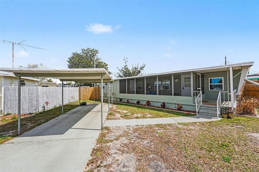 Newly updated mobile home in the heart of Holiday, FL. Located in the Buena Vista Mobile Home Park, a family community where you OWN THE LAND, PETS ARE WELCOME, and you enjoy LOW HOA FEES of $109.00 a quarter which includes your trash pickup twice a week and street lights! This stylish home features 2 bedrooms and 1 full bath with an open floor plan showcasing a large kitchen and living room. It includes new LPV flooring 2025, new energy-efficient windows throughout 2025, a new AC unit (2025), new privacy fencing added in 2025, and a large enclosed front porch area with new screen and light fixtures installed.  The floral landscaping really completes this home. Situated on almost 5,000 square feet of land that you will own, this property offers plenty of yard space for entertainment and recreational activities. Come Now as this one will not last long!