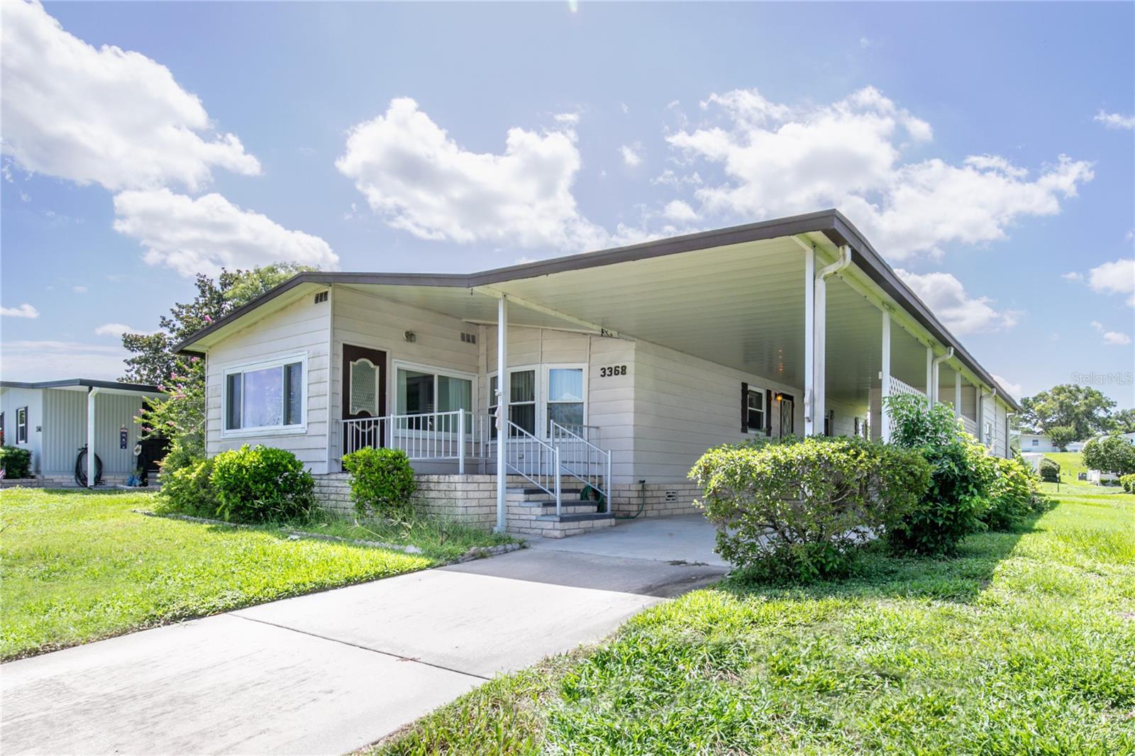 Well-maintained 2-bedroom, 2-bath manufactured home located in the highly desirable gated community of Zellwood Station. This spacious home features a bright Florida room, an exterior laundry room, an 8x8 storage room, and a covered carport with room for two vehicles. The open layout provides plenty of space for relaxing and entertaining, with natural light throughout and a functional flow from room to room. Zellwood Station is a vibrant 55+ community situated on over 800 acres with resort-style amenities and 24/7 manned security. Residents enjoy four community pools—one of which is heated year-round with a spa—as well as tennis and pickleball courts, a fitness center, walking and biking trails, shuffleboard, event lawns, and three stocked lakes for fishing. The community also features the Whistle Stop Restaurant, a shareholder-owned eatery offering great food and a welcoming atmosphere, and an 18-hole championship golf course with its own pro shop. Social activities are plentiful with events, dances, and classes hosted at the Co-op Clubhouse. Zellwood Station is conveniently located just minutes from Mount Dora, Apopka, and Orlando, with easy access to the 429 for quick trips to Disney World, Universal, and other Central Florida attractions.