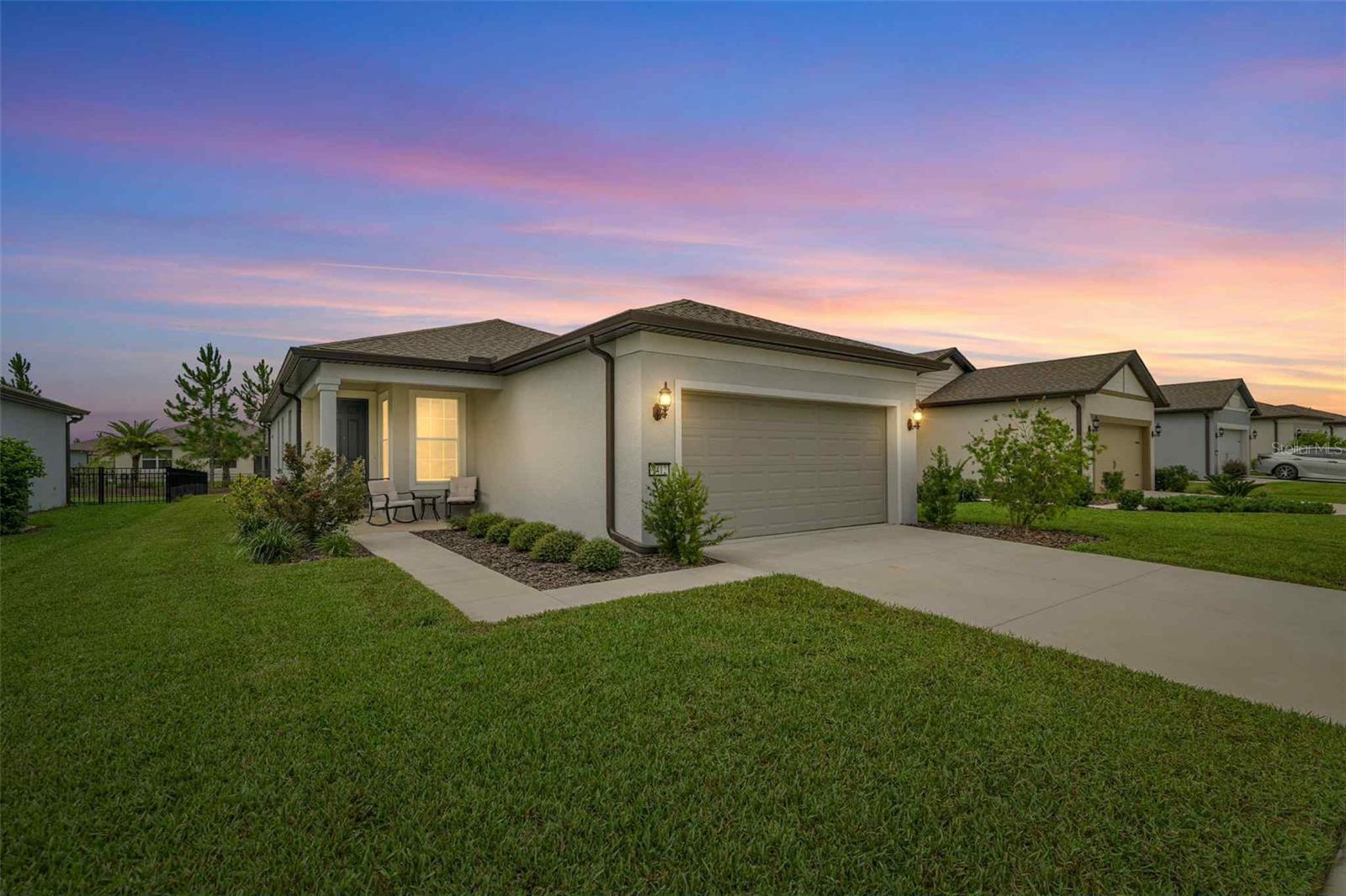 Located in the sought-after 55+ community of Stone Creek, this beautifully maintained Crestwood model was built just two years ago and offers a spacious open-concept floor plan. A standout builder upgrade includes 8-foot interior doors throughout the home, adding to its elevated design. The kitchen features a large island perfect for cooking and entertaining, while a flexible bonus room offers space for a home office or den. The primary suite includes a tray ceiling, walk-in shower, and dual sinks. Thoughtful upgrades include recessed lighting, exterior and lanai lighting, and extra-tall toilets. Step outside to a beautifully landscaped backyard with a round patio—ideal for outdoor dining or relaxing by a fire pit. As an added bonus, the home comes with lawn care equipment and a golf cart, both included—perfect for enjoying the community’s many amenities in style. Washer and dryer will stay, and furnishing is optional, making this home truly move-in ready.