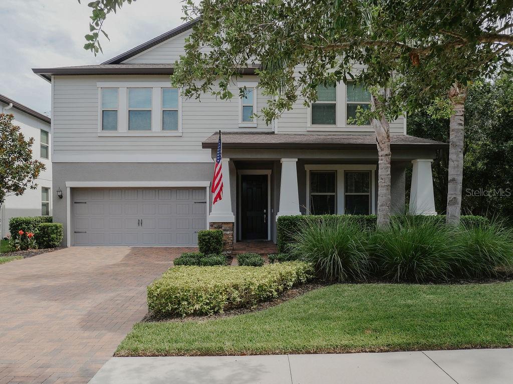 This large two-story home is located in the beautifully maintained community of Stafford Place in Tampa Palms. This house offers lots of curb appeal with its lush human-made and natural landscape. The contemporary design of the home's exterior features a large welcoming front porch with beautiful stone and stucco craftsman style square tapered columns. As you make your way inside the house, off the foyer you will find a formal dining room that can also be used as a front office with access to the Kitchen through the butler's pantry. The kitchen has lots of prepping space with granite counter tops and shaker-style cabinetry. There’s additional storage in the large walk-in pantry. The kitchen also has a large island with seating plus a dinette overlooking the spacious family room. Off the family room there is a first-floor laundry room, half bathroom and primary bedroom with a large ensuite and walk in closet. Access the rear screened in lanai from the family room. The backyard slopes downward with stairs to a paver courtyard with a stone firepit with lots of room for seating while enjoying the serene views of the conservation area. The back yard is fenced with black aluminum fencing. The upstairs features, four bedrooms, two bathrooms, an additional laundry room, a walk-in storage room which houses the two AC units and a massive bonus room for family entertainment. As if there isn’t enough space, this house offers a three-car tandem garage for your vehicles, additional storage, a workshop, yard equipment or even a gym. The house is located minutes away from the New Tampa Recreation Center with a variety of amenities such as a playground, dog park and skate park, easy access to I-75, nearby shops, restaurants, movie theater, including Wiregrass Mall and the Tampa Premium Outlets, family game entertainment and much more. Don't miss out on this perfect opportunity! This house and location are a must see!