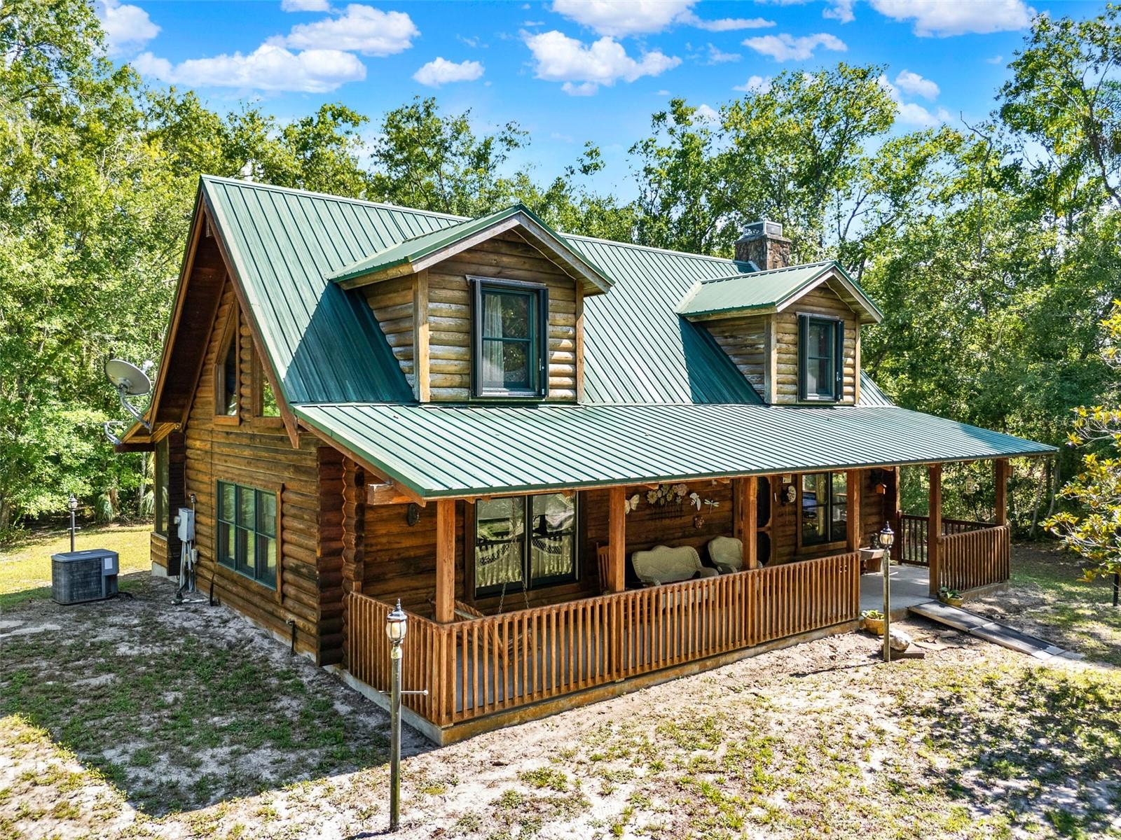 Dreaming of country charm, wide-open spaces, and endless possibilities?
This rustic and inviting 2-bedroom, 1-bath log cabin sits on over 8.5 acres of serene countryside and is bursting with potential. From the stunning exposed wood beams and soaring ceilings to the cozy wood-burning fireplace, every detail of this home exudes warmth and authentic log cabin character.
Zoned A-4 and already subdivided, the property includes two additional buildable parcels—perfect for constructing another home, guest house, barn, or creating a hobby farm or multi-generational family compound. With paved road frontage on two parcels and direct access to Pampas Nursery Road on the third, this property is ideal for both personal use and future development.
Imagine mornings collecting fresh eggs from your chicken coop, afternoons spent harvesting vegetables in your sun-soaked garden, and evenings riding horses beneath a canopy of trees. With abundant Florida sunshine, no HOA restrictions, and flexible zoning, the land welcomes equestrians, homesteaders, and forward-thinking developers alike.
Best of all, you don’t have to give up convenience to enjoy this rural lifestyle. New Smyrna Beach is just 15 minutes away, offering beautiful coastline and waterfront dining. Daytona International Speedway is only 20 minutes away for motorsports enthusiasts, and Daytona Beach International Airport is less than 30 minutes from your doorstep. World-famous Orlando theme parks are an easy 75-minute drive, making weekend getaways a breeze for you or future guests.
Whether you’re a developer seeking your next opportunity or a buyer craving space, privacy, and self-sufficient living—this one-of-a-kind property delivers. Opportunities with this much land, zoning flexibility, and development potential—so close to the beach—are extremely rare.
Call today to schedule your private tour, walk the property and discover all the possibilities waiting here. Don’t miss your chance to own a unique piece of Old Florida charm with room to grow!