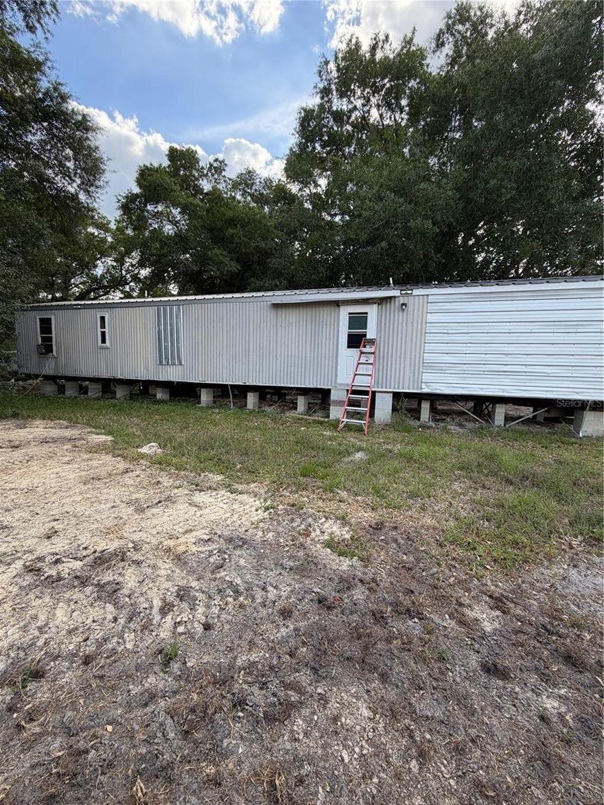 Solid investment property featuring a 2 bedroom, 2 bathroom mobile home situated on a spacious half-acre lot. Property offers strong rental potential with room for future improvements, expansion, or redevelopment.