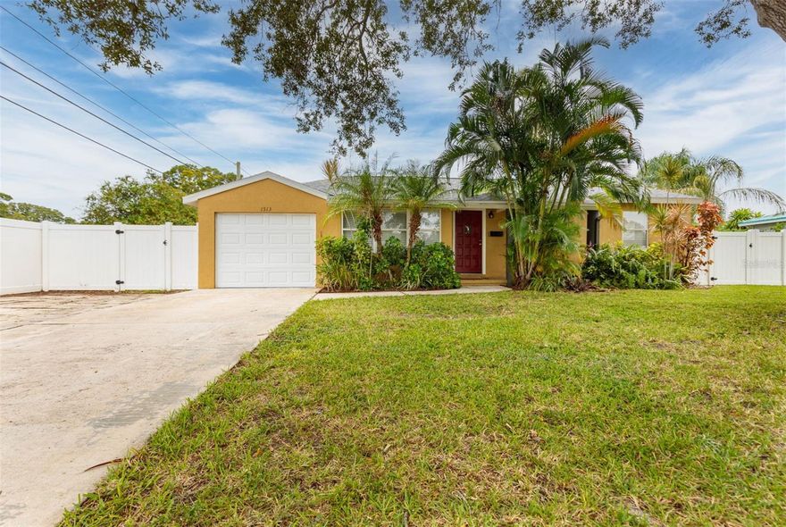 ~FANTATIC PRICE IMPROVEMENT ~Introducing this charming 3-bedroom PLUS DEN/OFFICE/4th Bedroom home nestled in the serene Tyrone Gardens neighborhood. Situated on a quiet street, this wonderful residence is a hidden gem in St. Petersburg, The best part? No flood insurance required! Enjoy tropical landscaping in the front yard as well as two majestic oak trees for shade and beauty. This 1950's block home has a modern aesthetic with textured stucco accents, a single-car garage and a generously sized driveway that offers ample parking for guest, RVs or even your boat! This move-in ready home has a freshly painted interior, ceiling fans, tile flooring and hardwood. Natural light floods the home through numerous updated windows - some with in-window slide shades, creating a warm and welcoming ambiance. The kitchen features real wood cabinets and a walk-in pantry plus the laundry room is inside.  This home boasts a unique feature—a 4th bedroom/bonus room with a vaulted ceiling. This versatile space can serve as a home office, a cozy den, or an extra guest bedroom. Looking for an extra bathroom? there's room for that too! Sliding glass doors lead to a backyard patio, where you can take the festivities outdoors and enjoy the Florida sunshine and enjoy this over-sized lot - Heck! There is lots of room to add a Pool! The spacious backyard is fully enclosed with a vinyl privacy fence, providing you with a private oasis to relax and unwind. A sizable storage shed is a practical addition, offering ample space for all your extras, from gardening tools to outdoor equipment. In addition to its outstanding features, this home is ideally located, offering equal proximity to both downtown St. Petersburg and the beautiful beaches of the Gulf Coast. With A NEW ROOF, room for expansion, and the freedom to park your boat or RV on the oversized lot, this property is ready to be your new home!