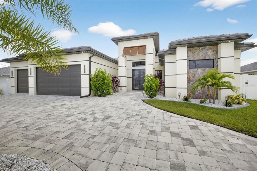 One or more photo(s) has been virtually staged. Experience the pinnacle of Florida WATERFRONT living in this NEW CONSTRUCTION - GULF ACCESS masterpiece ideally located in the prestigious Pelican neighborhood of Southwest Cape Coral. The home offers 3 spacious Bedrooms + a versatile Den that is ideal for a home office or guest suite. The open floor plan gives you over 2,200 sq. ft. of living space! This custom-built home perfectly blends modern elegance, coastal charm, and everyday comfort designed for both relaxation and entertaining along with Eastern rear exposure. 

From your backyard, enjoy sweeping canal views and direct access to the Gulf, a dream for avid boaters, complete with a dock and 13,000-pound lift accommodating up to a 30-foot vessel. Inside, the open concept layout boasts sleek tile flooring throughout, a stunning kitchen with quartz countertops, custom cabinetry, and high-end stainless appliances and a large walk-in pantry. Expansive living and dining spaces flow seamlessly to the outdoors, creating an effortless indoor-outdoor lifestyle. The primary bedroom is a sanctuary of its own featuring a spa inspired bathroom with dual vanities, soaking tub, and a creative walk-in shower. Large walk-in closets with high-end shelving and plenty of storage space. Step outside to your private resort style lanai with a custom heated/saltwater pool and spa (controlled through an Smart App), summer kitchen, built in grill, and TV console with an electric fireplace, creating the ultimate setting for entertaining or unwinding at the end of the day. 

Additional highlights include impact windows and doors, electric blinds, tile roof, energy efficient construction, fenced yard and city water and sewer with all assessments paid. Large circle driveway with a 3 – car garage and beautiful landscaping with palms galore. Located just minutes from dining, shopping, and Cape Coral’s vibrant waterfront lifestyle, this property offers unmatched convenience with a sense of exclusivity. Do not miss your chance to own a brand-new luxury Gulf Access home, schedule your private showing today!
