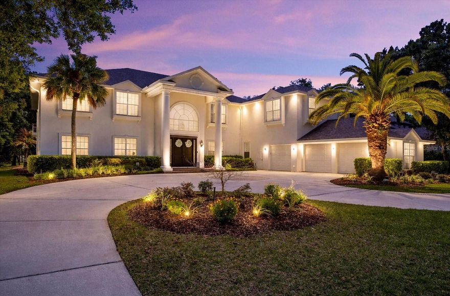 One or more photo(s) has been virtually staged. This stunning estate blends timeless elegance with modern luxury, set along the 8th fairway of the Tampa Palms Golf & Country Club. Located in The Reserve, one of Tampa Bay’s most exclusive guard-gated communities, it spans over 7,700 square feet and has been transformed by a recent $500,000 renovation. The soaring two-story living room offers panoramic views of conservation land, sparkling water, and the manicured golf course, while rich handscraped hardwood floors and designer finishes add warmth and style throughout. The gourmet kitchen features Calacatta Bianco quartz, custom cabinetry, Sub-Zero and Thermador appliances, whole house water filtration, including reverse osmosis in the kitchen, 2 tankless water heaters and impact windows throughout,  plus a walk-in pantry and built-in workstation—perfect for both everyday meals and entertaining. Five spacious bedrooms each have their own ensuite bath, with the primary suite opening to a private lanai and sun terrace, and a spa-like bath with a freestanding tub and dual walk-in closets, one doubling as a nursery or retreat. Outside, a screened lanai frames the resort-style pool and spa, alongside an outdoor kitchen with an Alfresco grill, sink, and beverage fridge, all overlooking serene conservation and golf views. Additional highlights include a custom third-floor theater, dedicated office, billiards room, and thoughtful upgrades throughout.