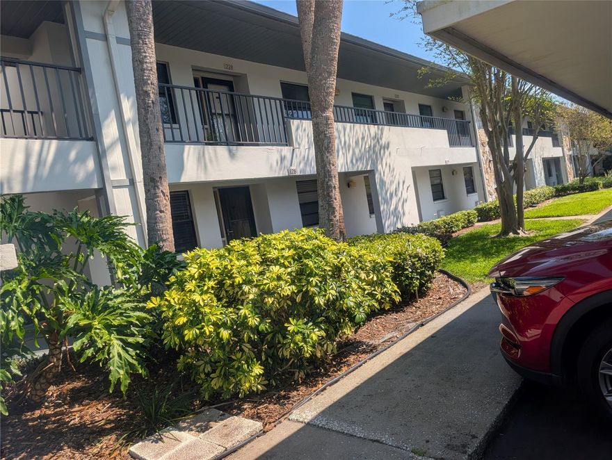 Discover a hidden gem in this small (43 unit) 55+ complex, BUILT IN 1984, in the heart of St. Petersburg - Welcome to Harshaw Lake Park! MOVE-IN READY ground floor 2 bedroom 2 bath condo (1,140 htd. sqft) with enclosed Florida room and INSIDE LAUNDRY! The inviting EAT-IN KITCHEN features newer Whirlpool and Kenmore appliances, Granite counters & tile backsplash, new faucet, modern designer-style lighting, and ample wooden cabinet space - perfect for cooking & entertaining. Designed for comfort, the open-concept split floor plan allows for seamless flow and privacy between living spaces. Enjoy your morning coffee in your private "backyard oasis" overlooking the tranquil gardens. The primary suite features double closets, including a walk-in closet, an ensuite master bath with easily accessible shower, security handles & cosmetic vanity; direct access to back patio and laundry room ("Whirlpool" washer/dryer convey). Newer "Champion" A/C (2020) with UV light, water heater (2021), ceiling fans, carpets, tile & laminate flooring, linen closets, NEWER ELECTRIC PANEL BOX &  exterior front storm door. Enjoy the deeded carport (#129) directly in front of your home - making grocery trips effortless. NO FLOOD ZONE! The low $656 monthly fee includes: water, sewer, trash, cable, all exterior maintenance including the roof (2018), pest control, clubhouse, pool, private roads, master insurance policy for buildings and liability - all you worry about is power and Internet. ANNUAL RENTALS & 1 SMALL PET (CAT) OK. Harshaw Lakes Community is beautifully maintained with manicured gardens, a refreshing pool, barbecue area, and clubhouse that hosts frequent social events. The search is over - come, look, and make it your own!