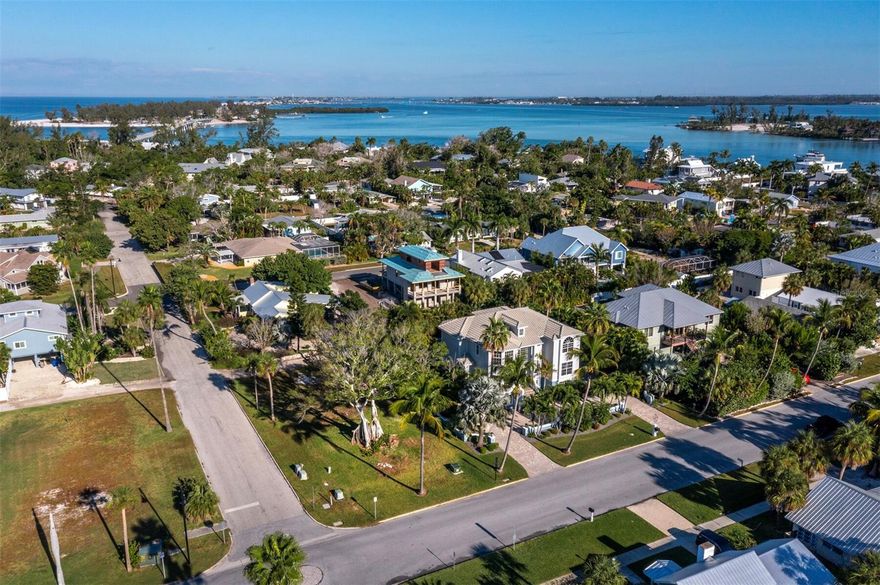 Discover the irresistible charm of historic Longbeach Village and seize a rare opportunity to build your dream island home on Longboat Key. Welcome to the lowest priced vacant single-family parcel available on Longboat Key, an exceptional chance to design a custom residence just off the coast of Sarasota. This desired corner lot in the heart of the village offers flexible design possibilities, including optional rear alley access in addition to two street frontages, giving you potential entry on up to three sides of the property. Positioned within this golf-cart-friendly community, the homesite provides effortless access to everything that makes Longbeach Village so beloved. Enjoy the dazzling white sands and shimmering turquoise waters of the Gulf of Mexico just moments from your door, along with the serene beauty of Sarasota Bay at opposite end of Broadway, both only about a block away. Here, sunrise and sunset become part of your daily routine. Residents of the village enjoy numerous waterfront conveniences, including multiple neighborhood kayak launch points, two fishing piers, a community boat ramp and a variety of dining, shopping and fitness options within minutes of home. With no mandatory HOA, you can store your boat, golf cart, or other island toys beneath a beautiful new elevated home and fully embrace the relaxed coastal lifestyle. This exceptional piece of island real estate invites you to bring your vision to life. Start planning your dream home or private vacation retreat today and experience the unmatched charm of Longbeach Village for yourself.